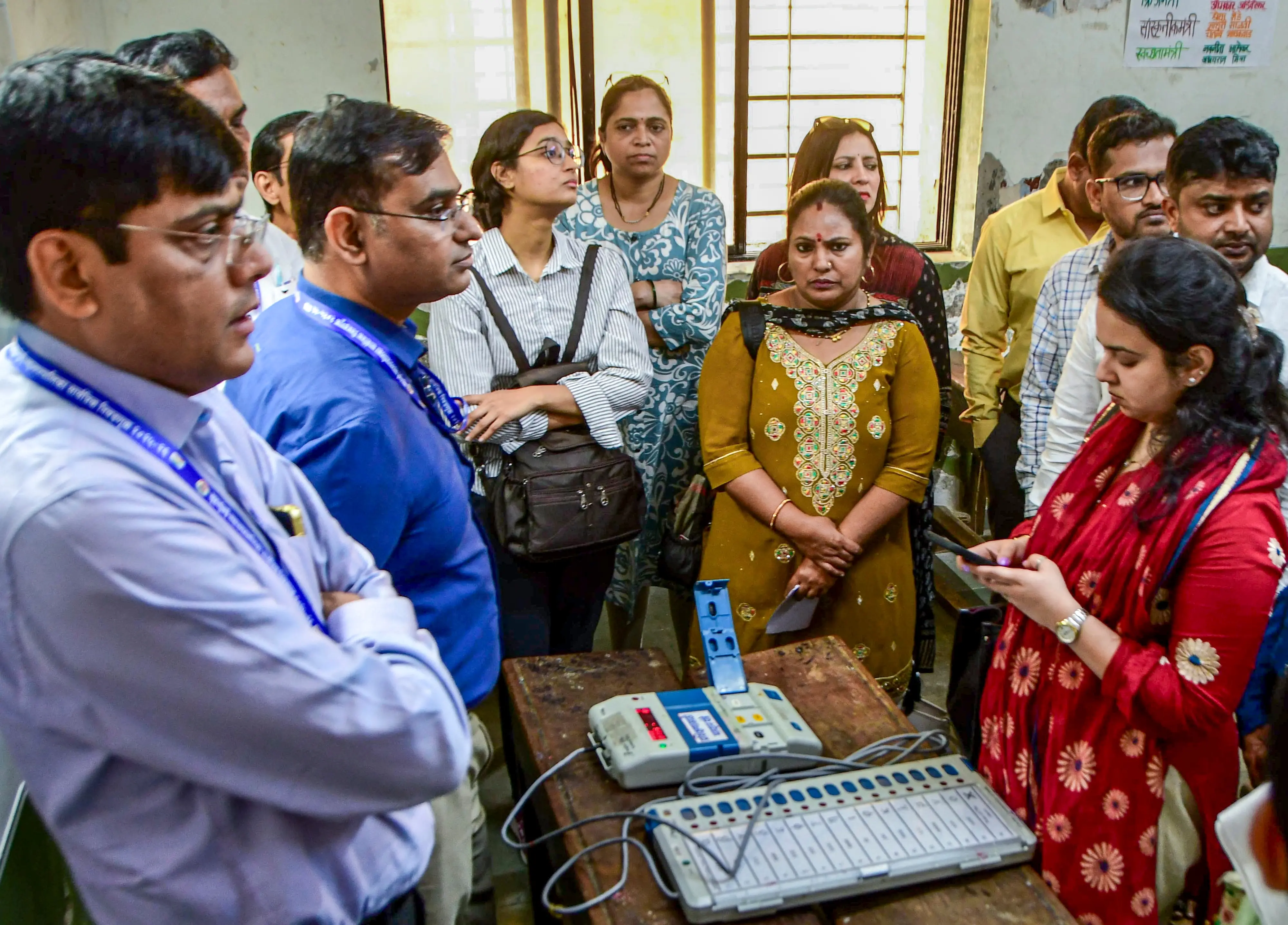 Election officials attend a training session on Electronic Voting Machines (EVMs) ahead of the civic polls, in Mumbai.| Photo: PTI