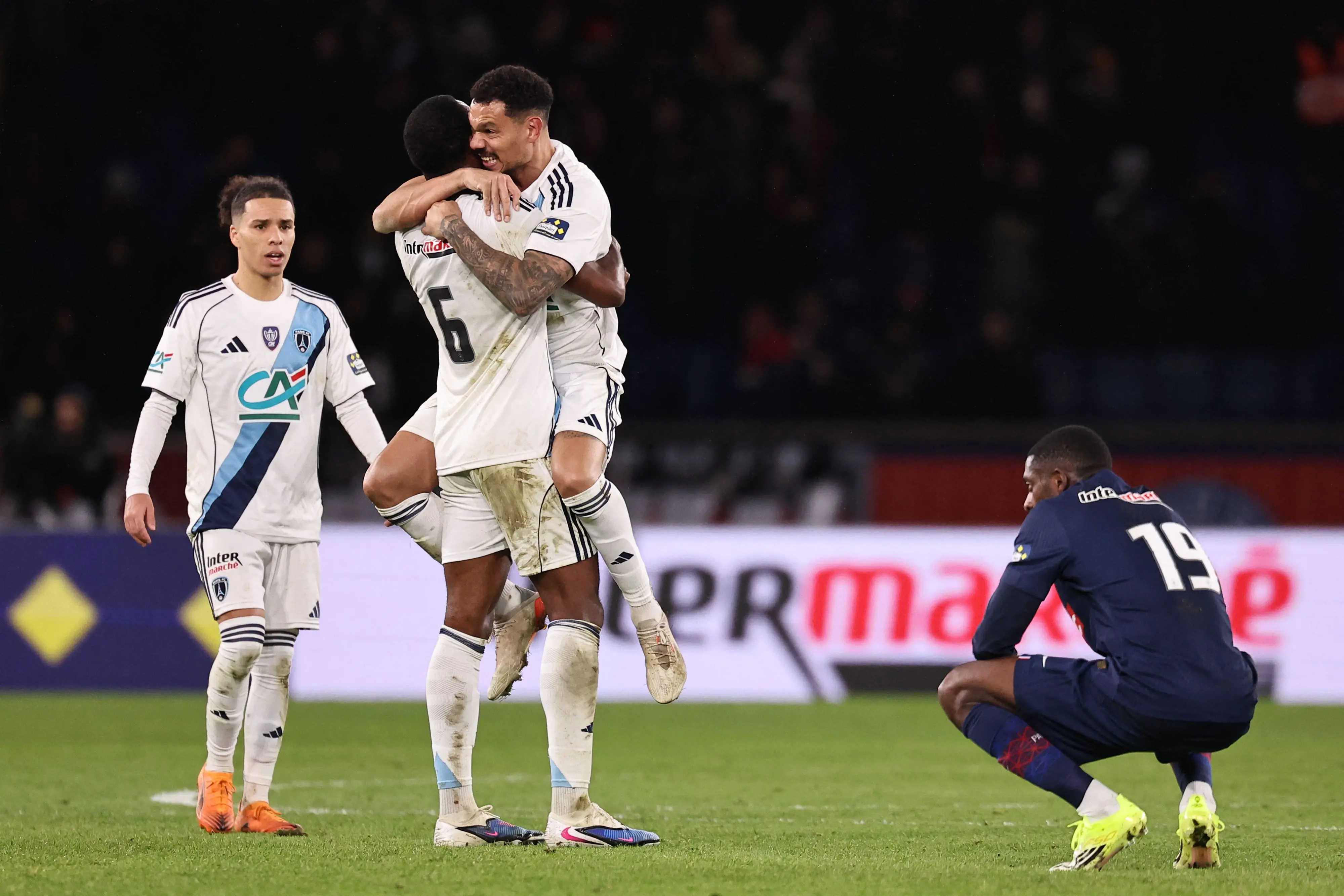 From L-Paris FC's French midfielder #17 Ilan Kebbal, Paris FC's Brazilian defender #06 Otavio and Paris FC's French defender #04 Timothee Kolodziejczak celebrate next to Paris Saint-Germain's French forward #19 Ousmane Dembele after winning their French Cup round of 32 football match against Paris Saint-Germain (PSG) | Photo: AFP