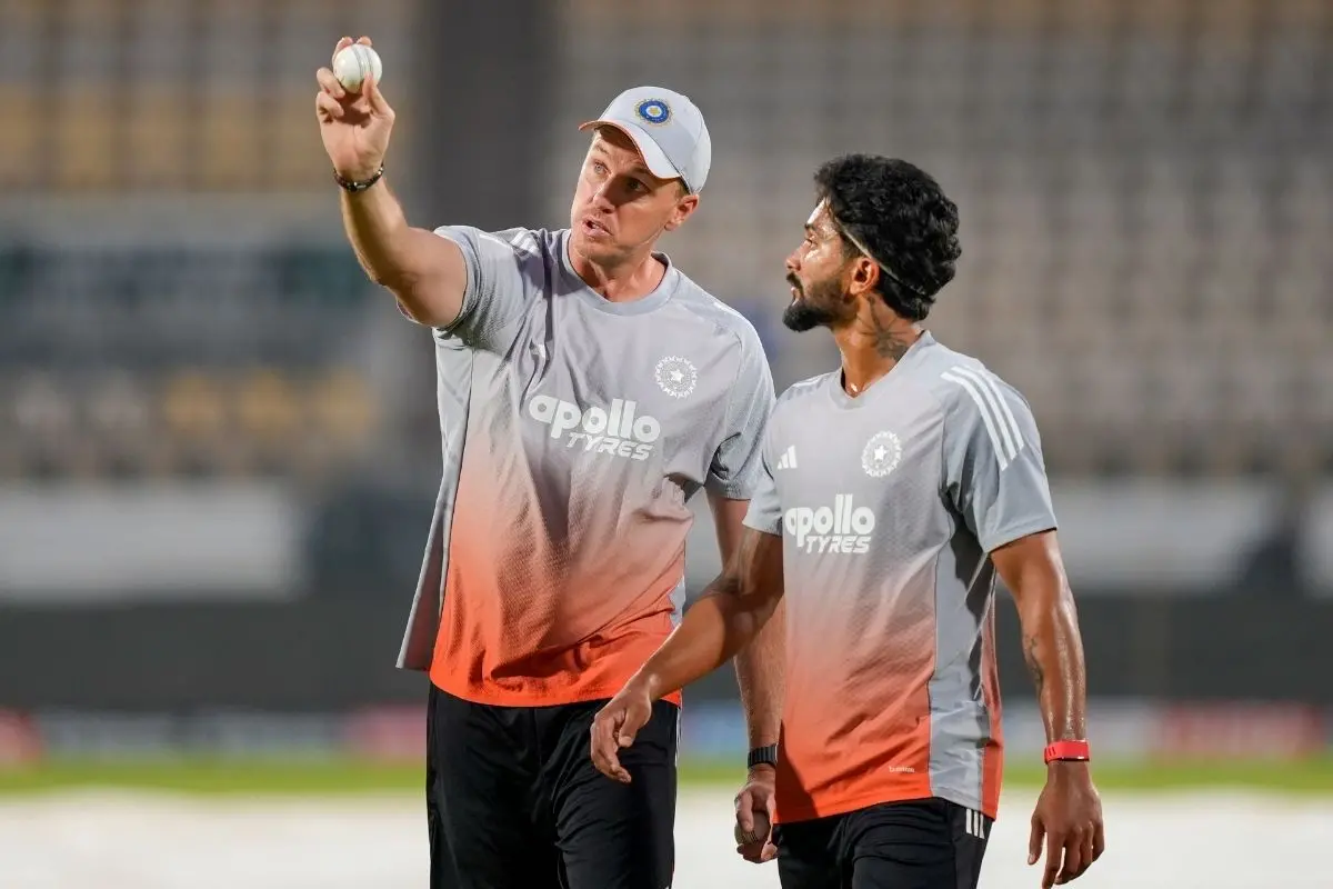 India's Nitish Reddy, right, with bowling coach Morne Morkel during a training session ahead of the second ODI cricket match between India and New Zealand, at Niranjan Shah Stadium in Rajkot. | Photo: PTI