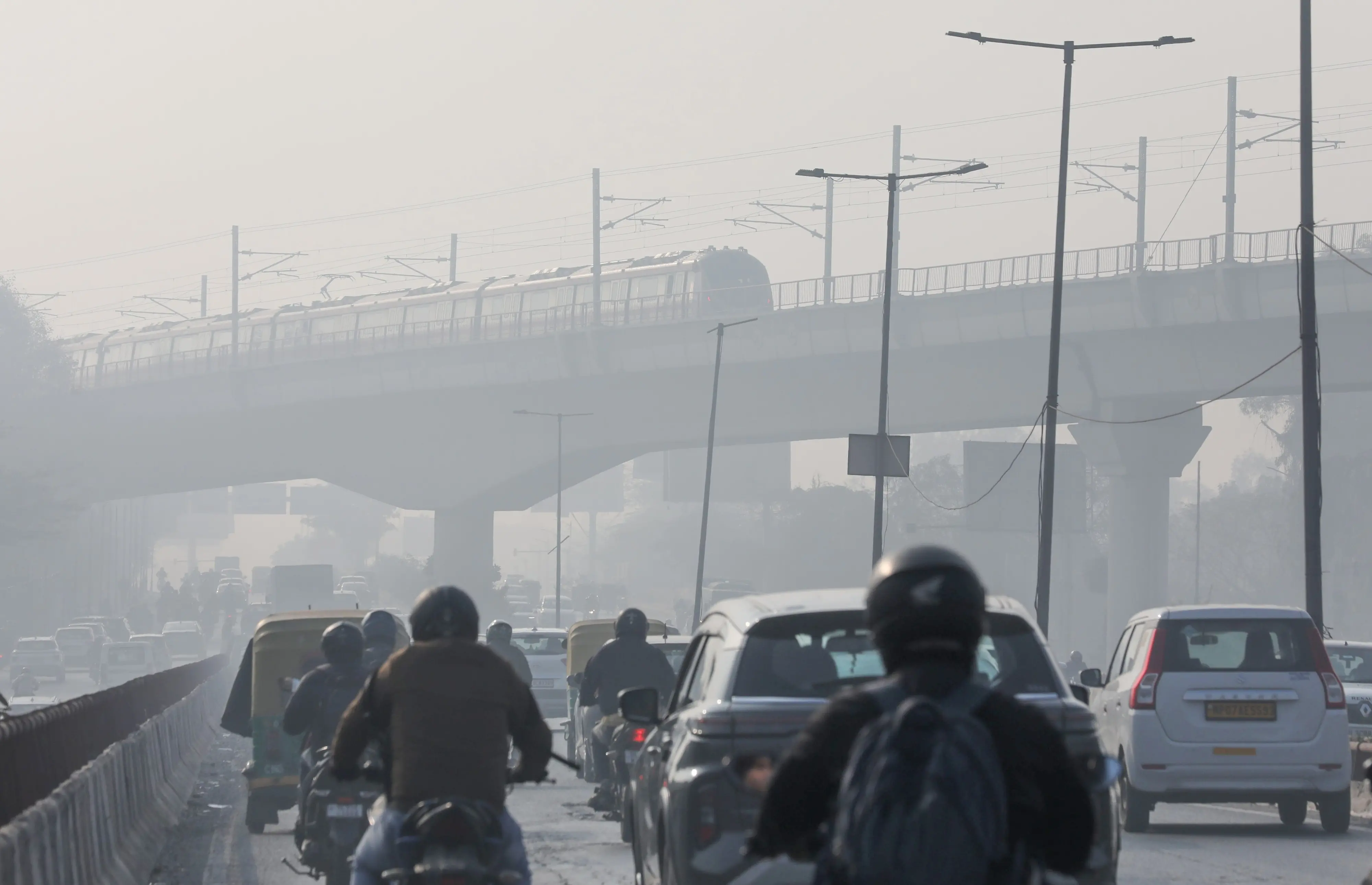 People commute on their vehicles amid smog on a cold winter morning, in New Delhi | Photo: ANI