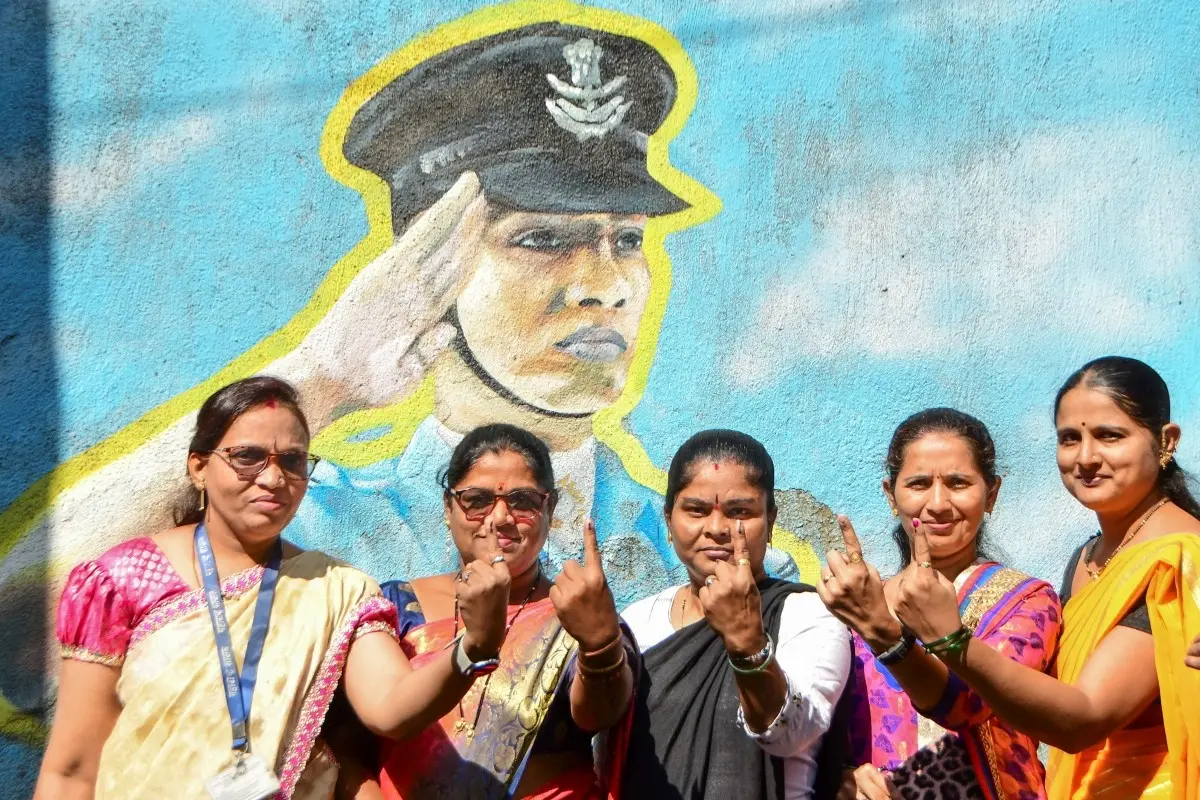 Voters show their ink-marked fingers after casting their votes at a polling station during the Brihanmumbai Municipal Corporation elections in Mumbai
