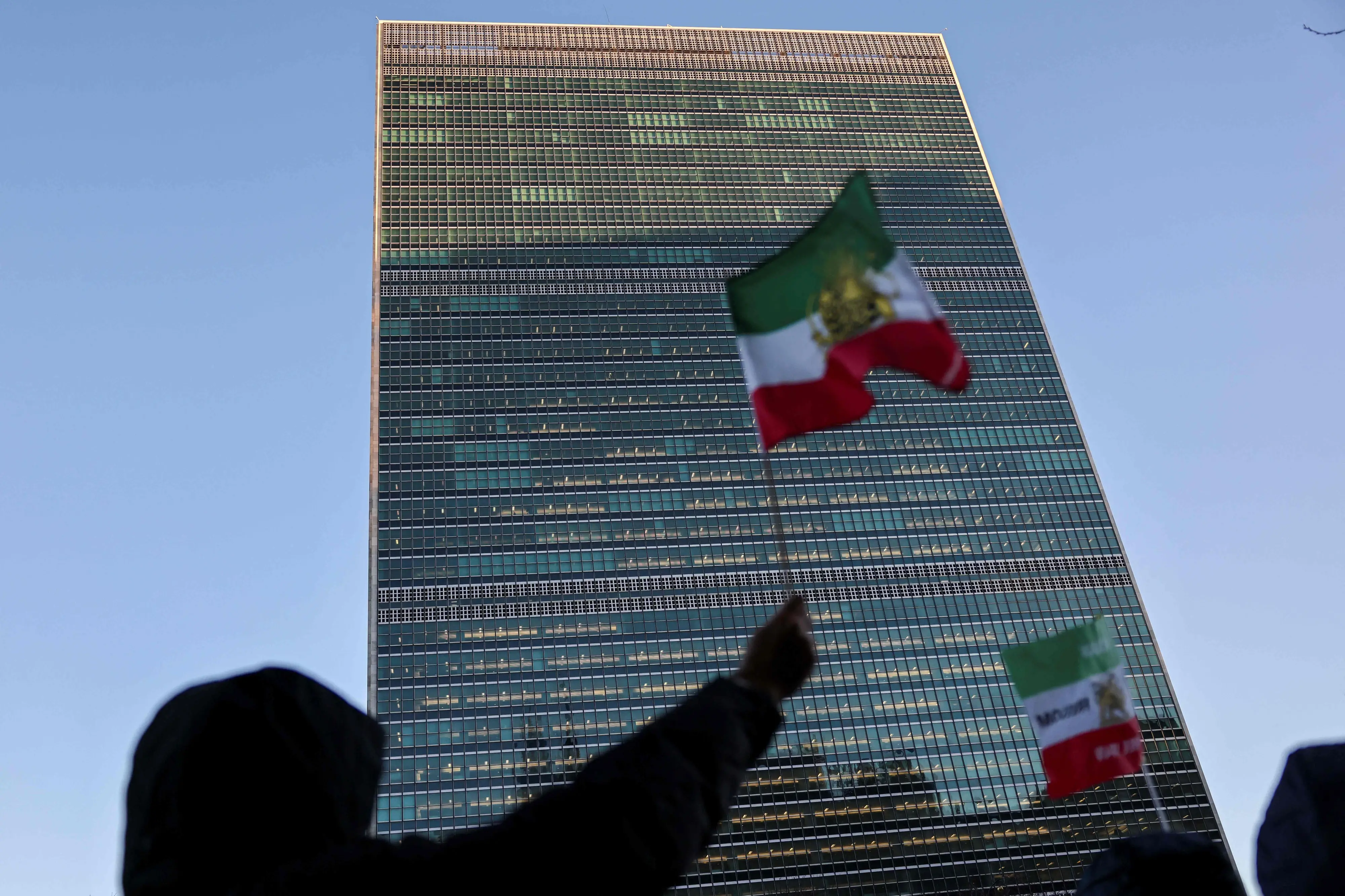Protesters wave the pre-Islamic Revolution Iranian flag outside UN headquarters during a United Nations Security Council meeting on Iran in New York | AFP