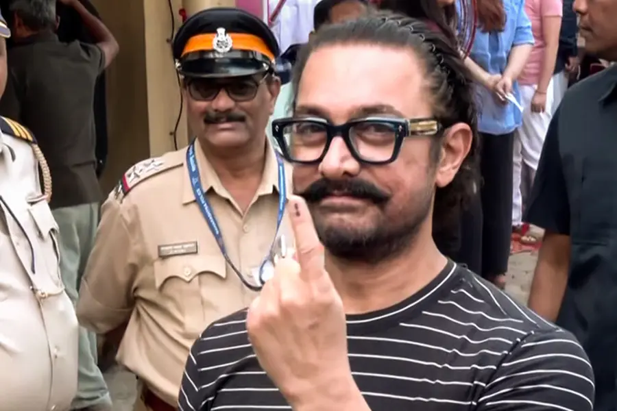 Bollywood actor Aamir Khan showing his inked finger after voting and interacting with journalists during the Maharashtra local body elections.