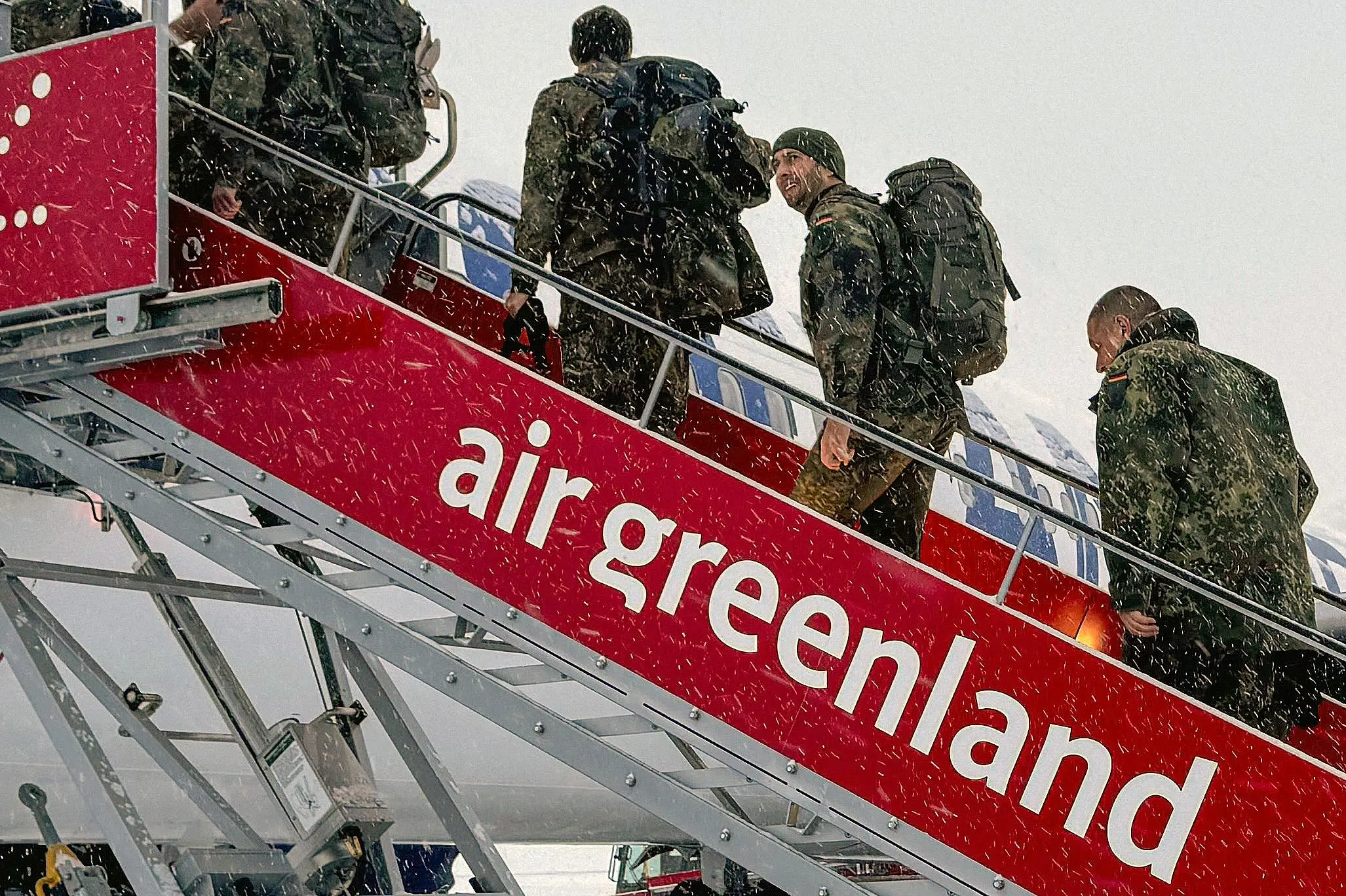 Military personnel from the German armed Forces Bundeswehr board Icelandair flight  leaving Nuuk airport for Reykjavik  in Nuuk, Greenland | AFP