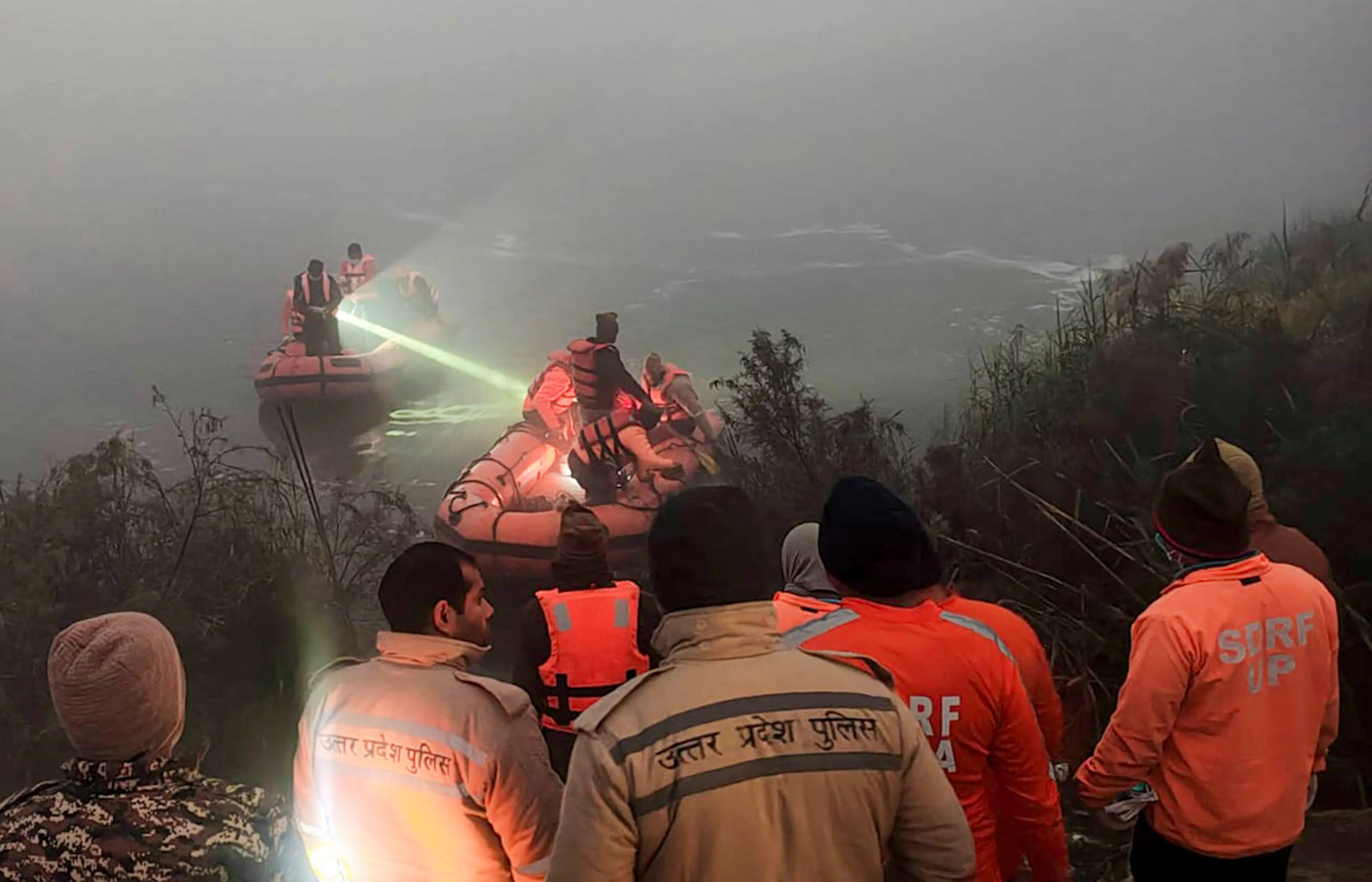Police and State Disaster Response Force (SDRF) personnel conduct a search operation after a 27-year-old software engineer died on Saturday after his car went out of control and fell into a 20-feet-deep water-filled pit that was dug for the basement of an under-construction building Photo: PTI
