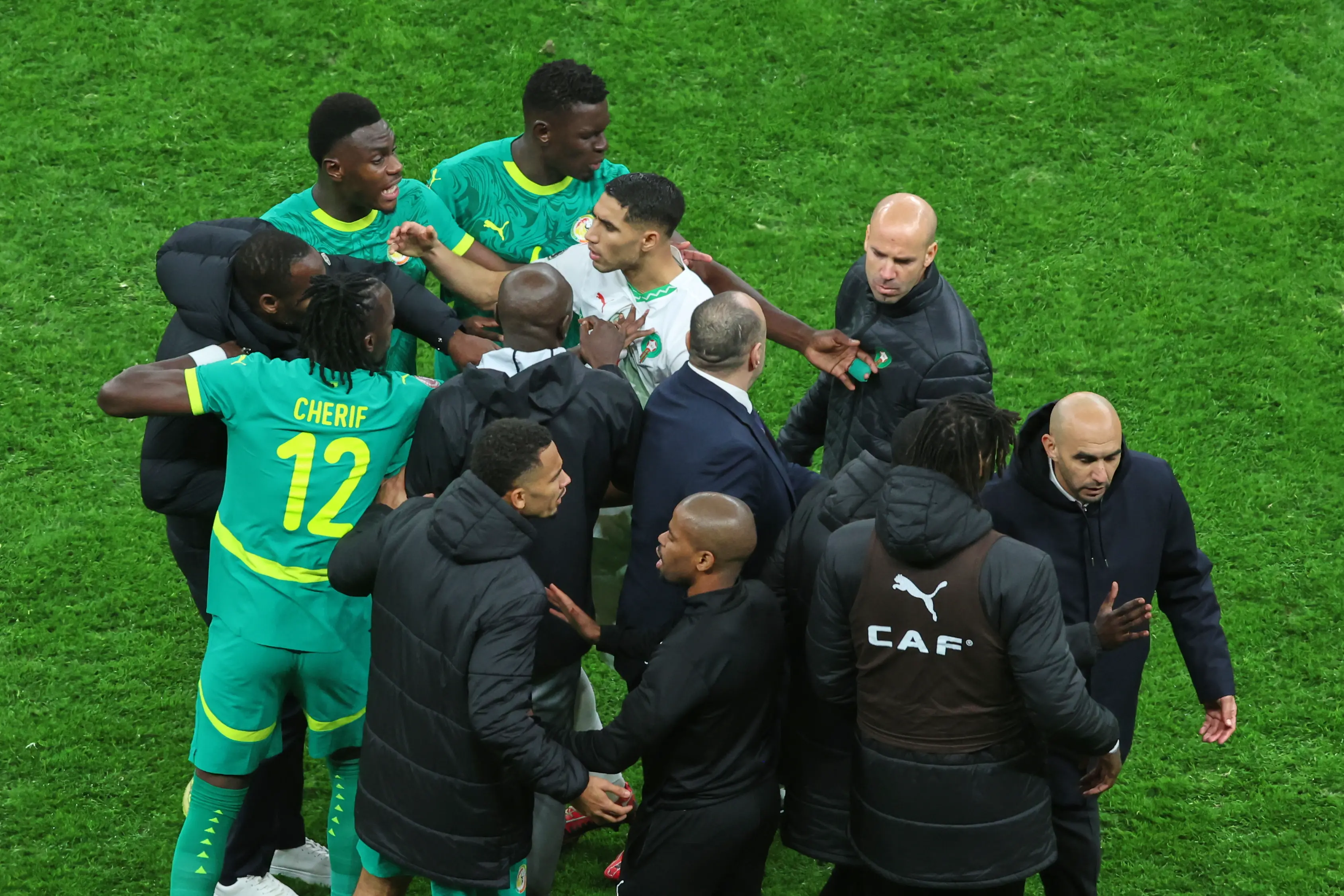 Morocco's Achraf Hakimi, center, clashes with Senegal players after a controversial penalty was awarded to Morocco late on during the Africa Cup of Nations final | AP