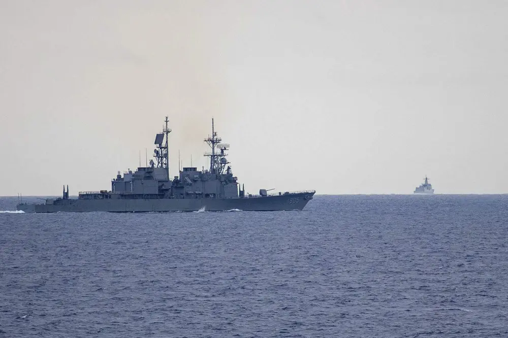 Taiwan guided missile destroyer Ma Kong DDG1805, left, monitors Chinese guided missile destroyer Xi'an DDG15, right, near Taiwan | File photo: AP