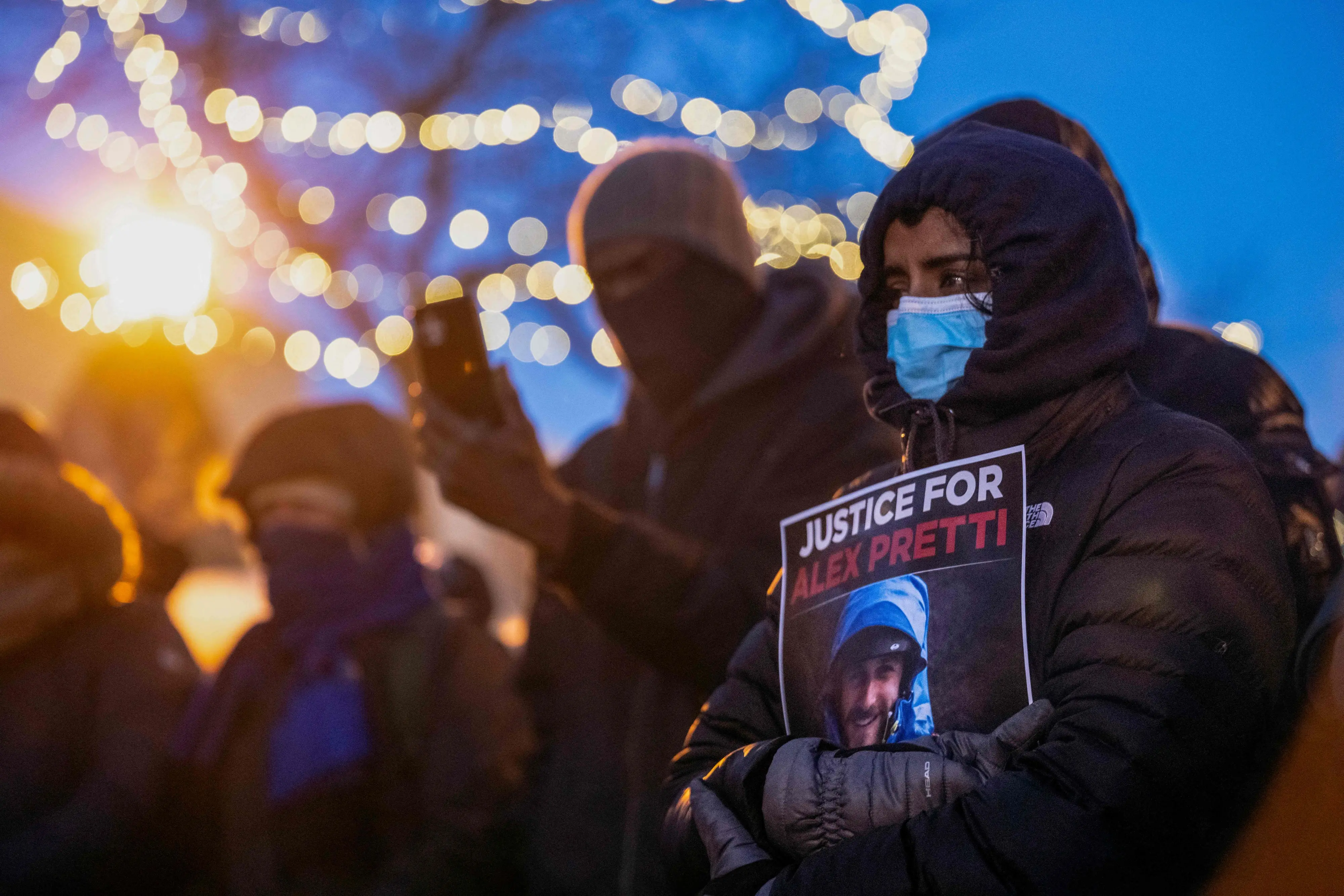 People mourn at a makeshift memorial in the area where 37-year-old Alex Pretti was shot dead by federal immigration agents | AFP