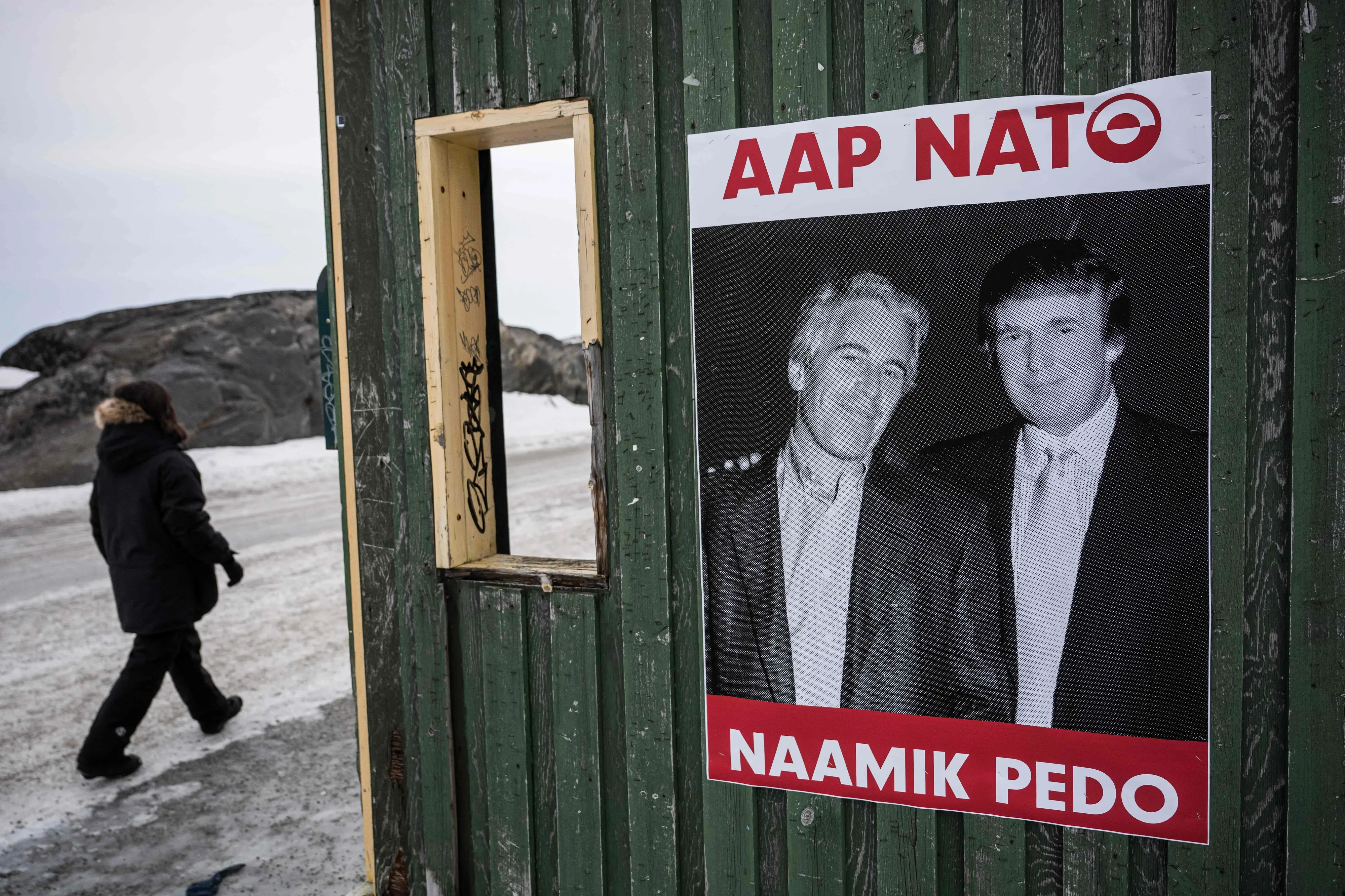 A poster showing Jeffrey Epstein and US President Donald Trump with the text in Greenlandic "YES NATO NO PEDO" is displayed on a bus stop shelter in Nuuk, Greenland | AFP