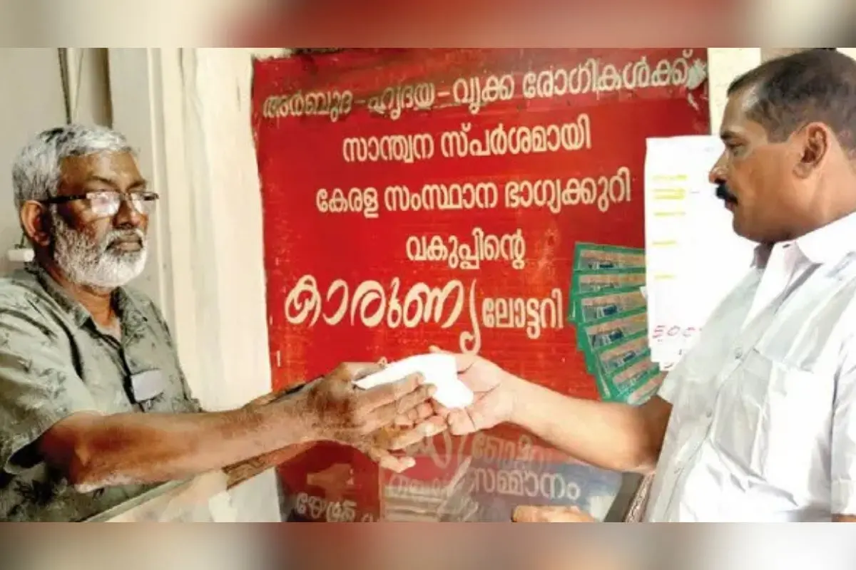 Sudheeq, owner of New Lucky Centre in Kanjirappally which sold the prize-winning Christmas–New Year bumper, celebrates by distributing sweets to everyone at his shop