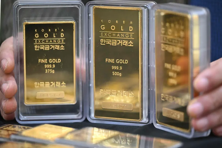 An employee displays gold bars at a store of the Korea Gold Exchange in Seoul