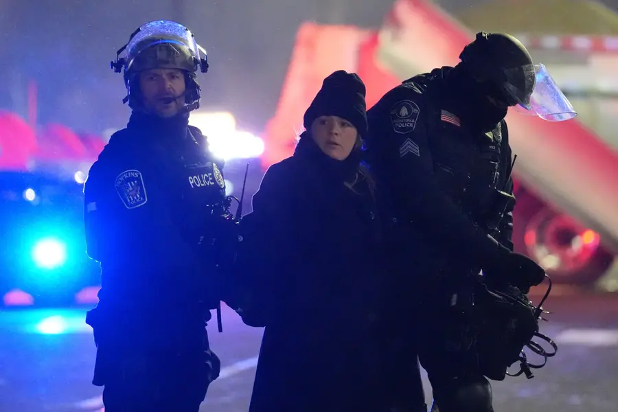 Law enforcement officers detain a person during a protest | AP