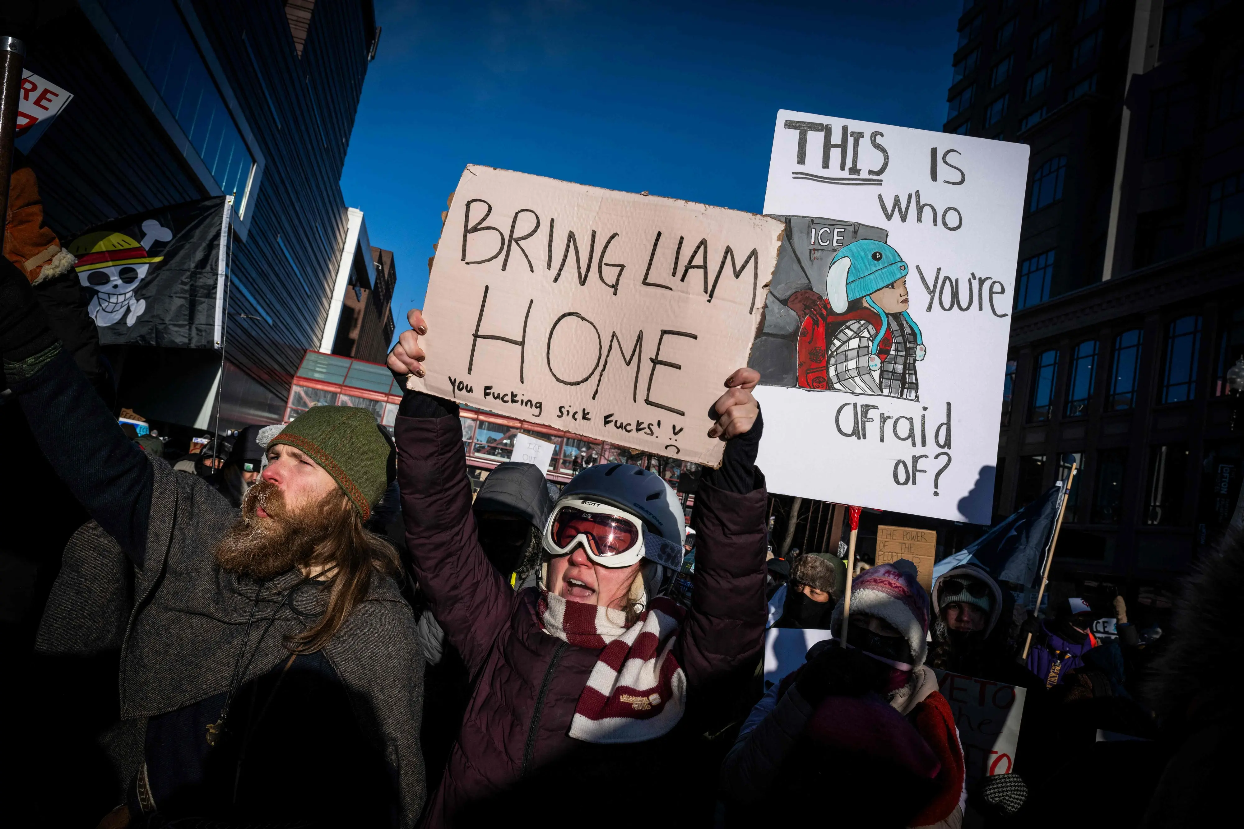 People hold signs in reference to five-year-old Liam Conejo Ramos who was held by immigration officers, during the "ICE out of Minnesota: Day of Truth and Freedom" protest in Minneapolis | Photo: AFP