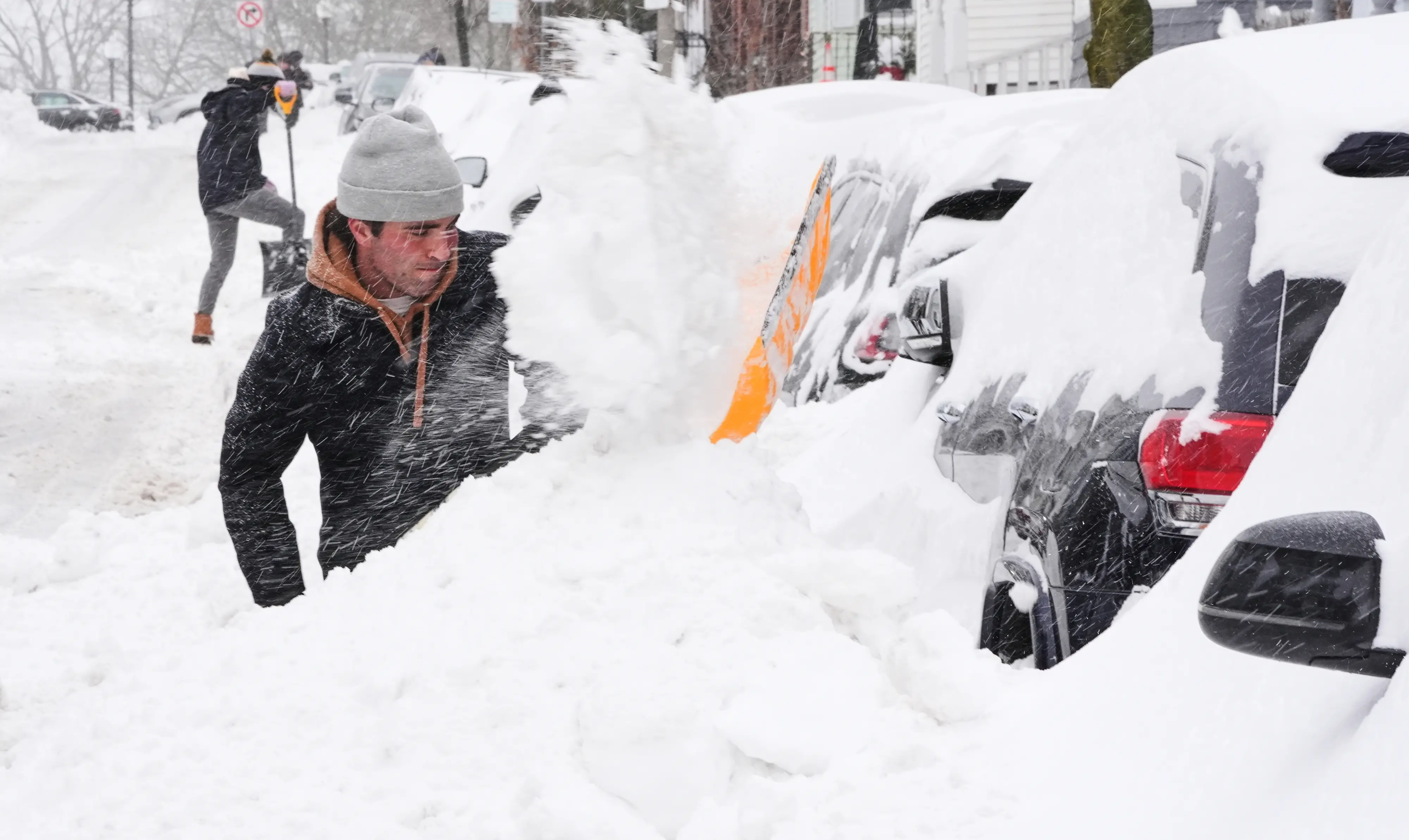 Residents dig out their cars in the South Boston neighborhood following a winter storm that dump more than a foot of snow across the region | Photo: AP