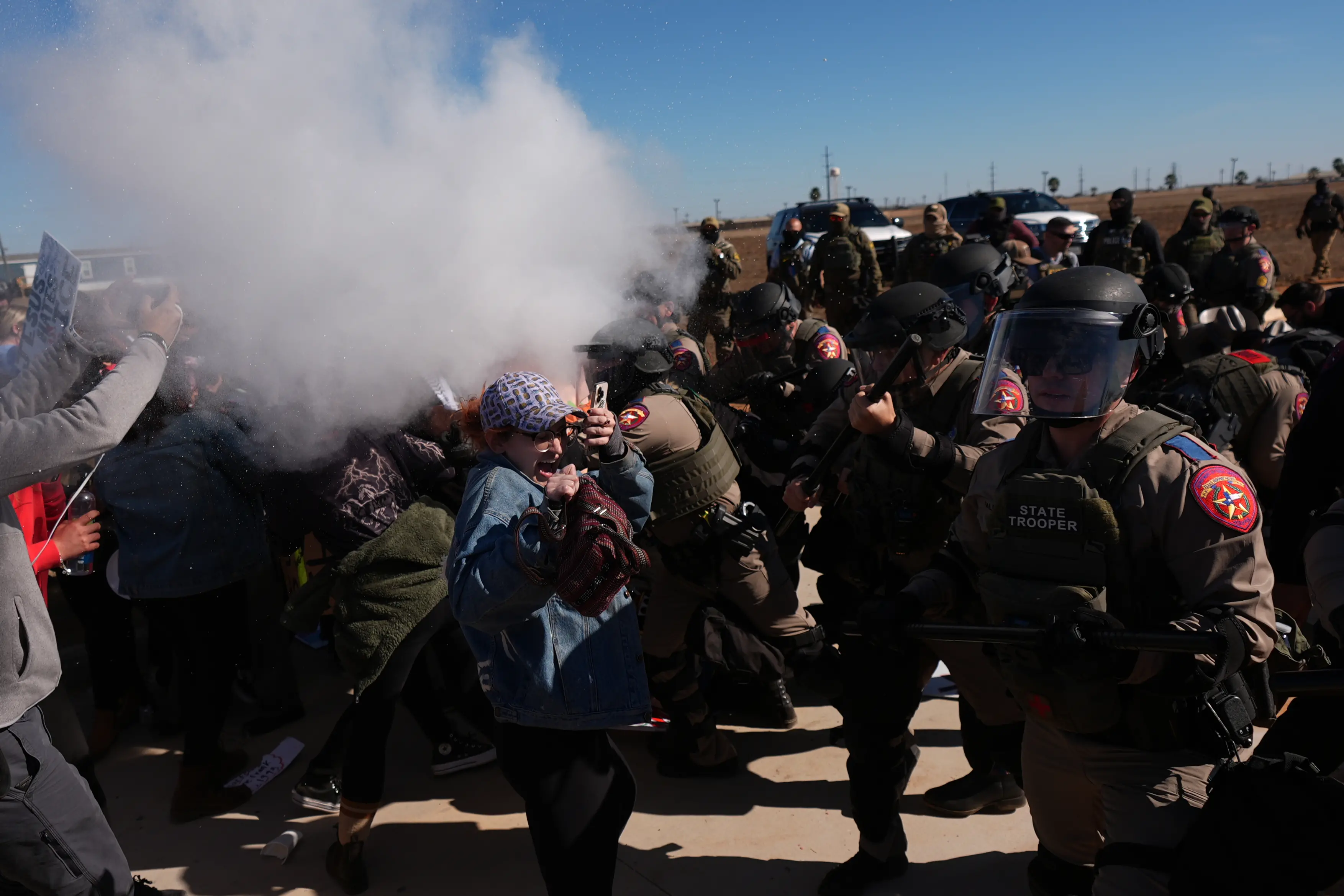 Pepper spray is used by Texas troopers to disperse protesters outside the South Texas Family Residential Center detention facility where Liam Ramos and his father are being detained | Photo: AP