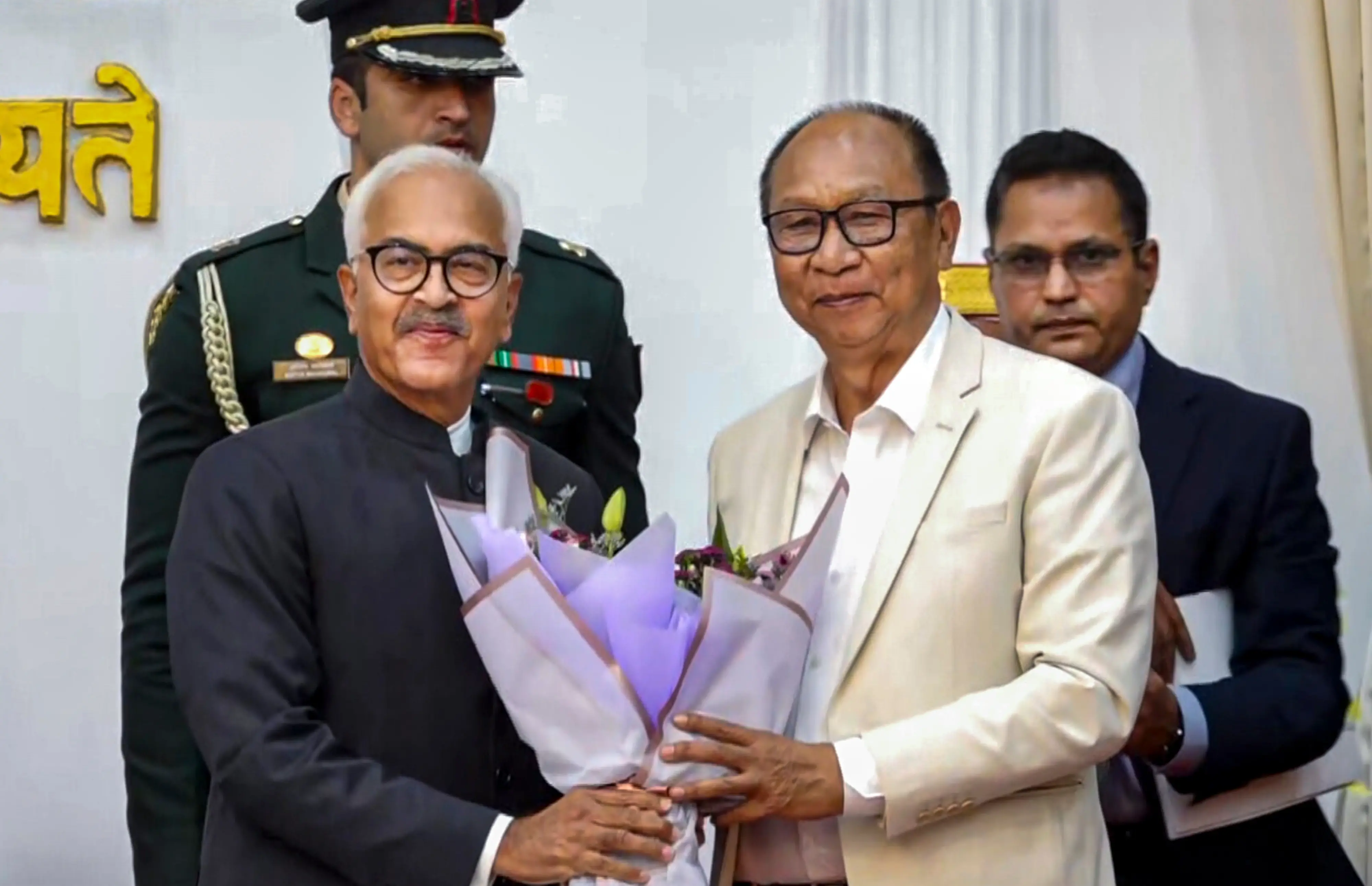 Manipur Governor Ajay Kumar Bhalla, left, felicitates BJP legislator Yumnam Khemchand Singh during the latter's swearing-in as the new state Chief Minister, in Imphal, Manipur | Photo: PTI