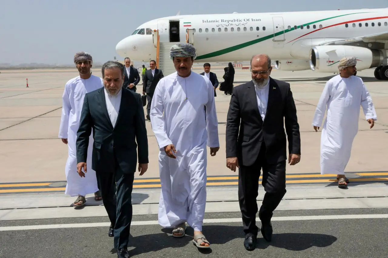 Iranian Foreign Minister Abbas Araghchi, left, is welcomed by an unidentified Omani official, center, upon his arrival at Muscat, Oman, for negotiations with U.S. | File photo: AP