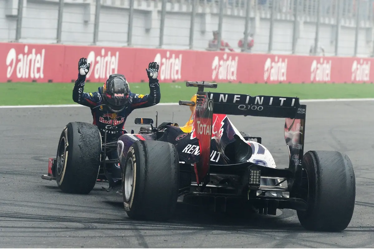 The iconic photo of 2013 Formula One World Champion Sebastian Vettel of Germany and Infiniti Red Bull Racing celebrating in front of the crowd on the main straight following the Indian Formula One Grand Prix at Buddh International Circuit on October 27, 2013 | Photo: Getty Images