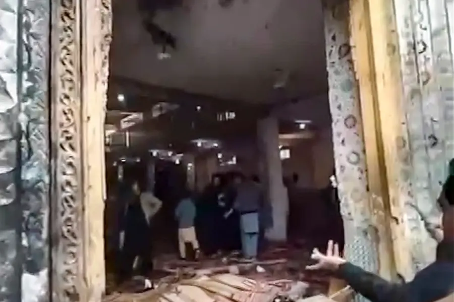 Locals gather at the site after a suicide bomber blew himself up at a mosque during Friday prayers, in Islamabad