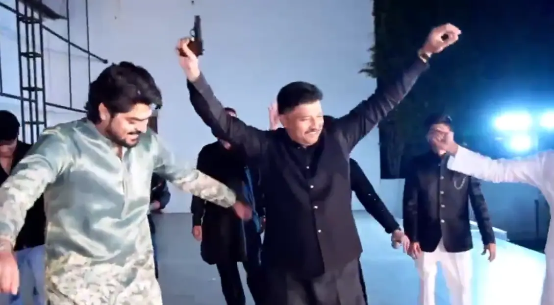 A video of Mateen Patil at the event holding a gun