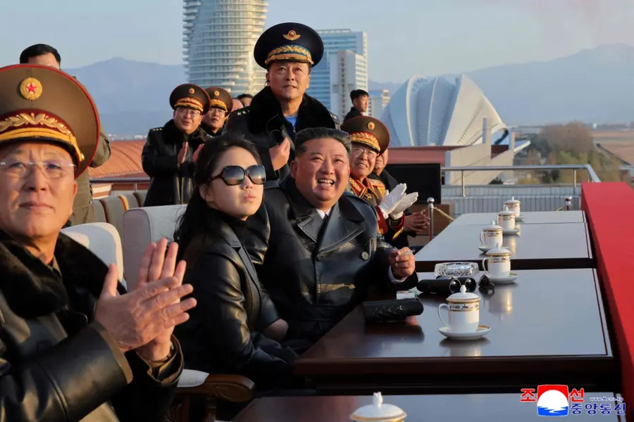 North Korean leader Kim Jong Un (3rd L) and his daughter Ju Ae (2nd L) watching a demonstration flight