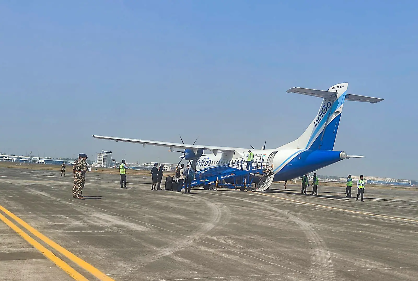 Security personnel and ground staff deployed near the IndiGo flight 6E3074 at Netaji Subhas Chandra Bose International Airport following a bomb threat, in Kolkata | Photo: ANI