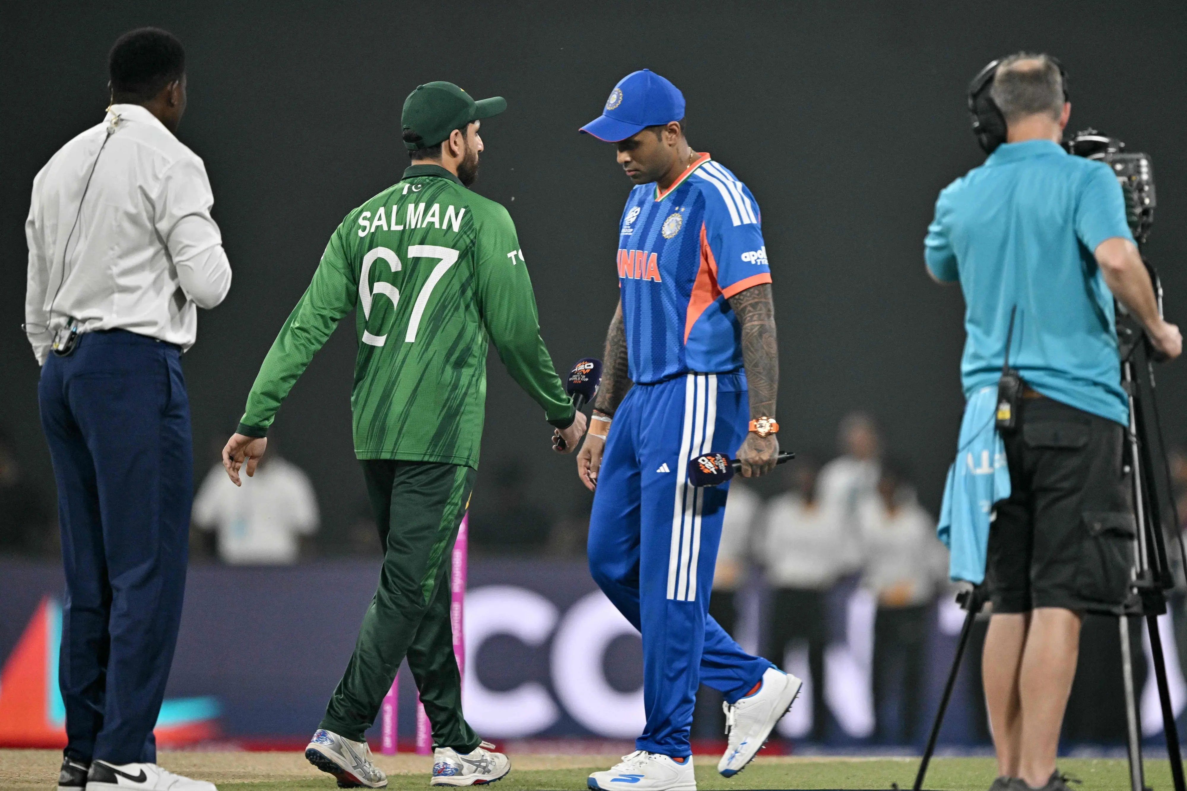 India's captain Suryakumar Yadav (2R) walks past his Pakistan counterpart Salman Agha (2L) after the toss before the start of the 2026 ICC Men's T20 Cricket World Cup group stage match between India and Pakistan | Photo: AFP