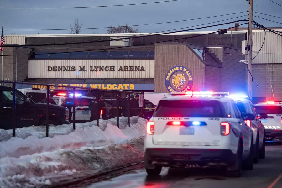 Police stand outside the perimeter they created around the Dennis M. Lynch Arena where a shooting occurred