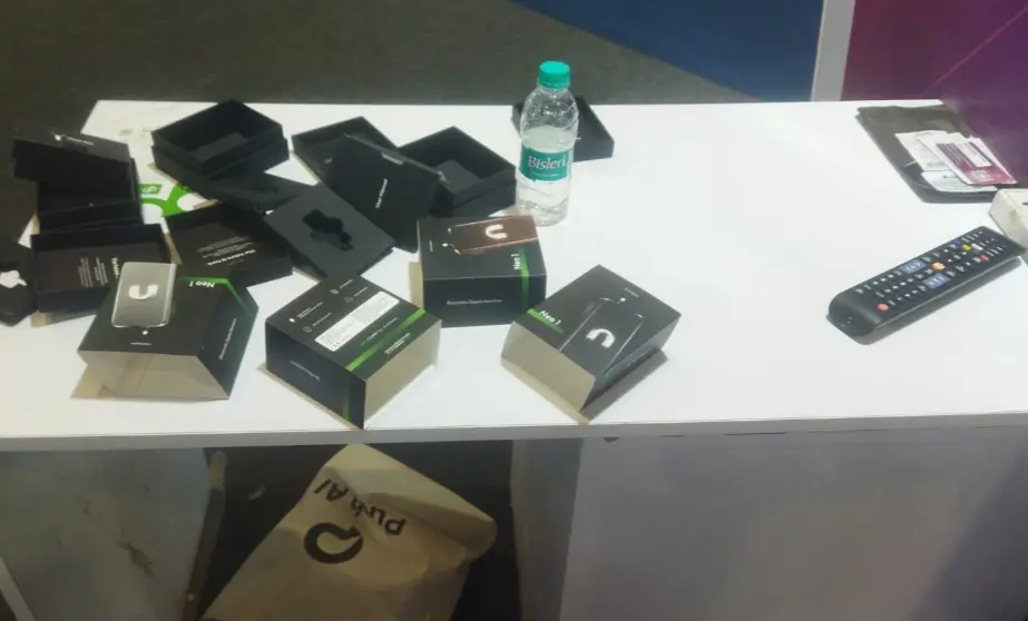 Photo shared by Dhananjay Yadav from the AI Summit showing empty boxes where the company's AI wearables went missing