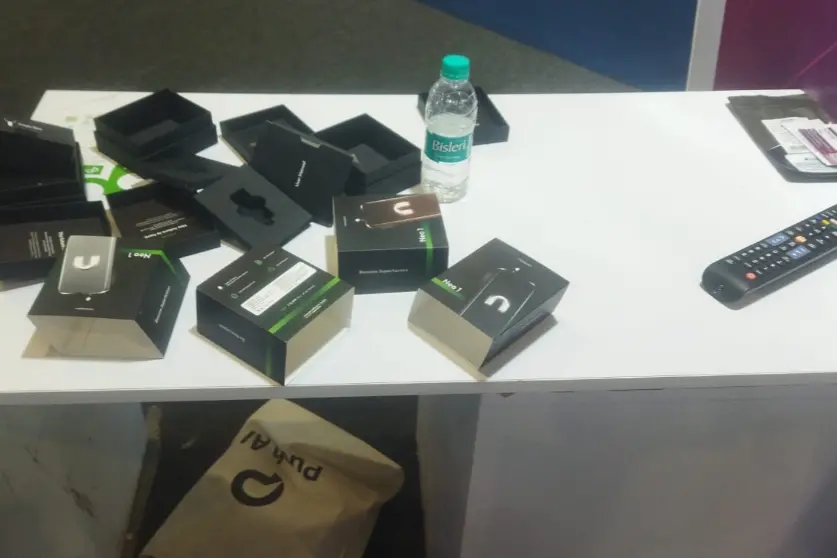 Photo shared by Dhananjay Yadav from the AI Summit showing empty boxes where the company’s AI wearables went missing