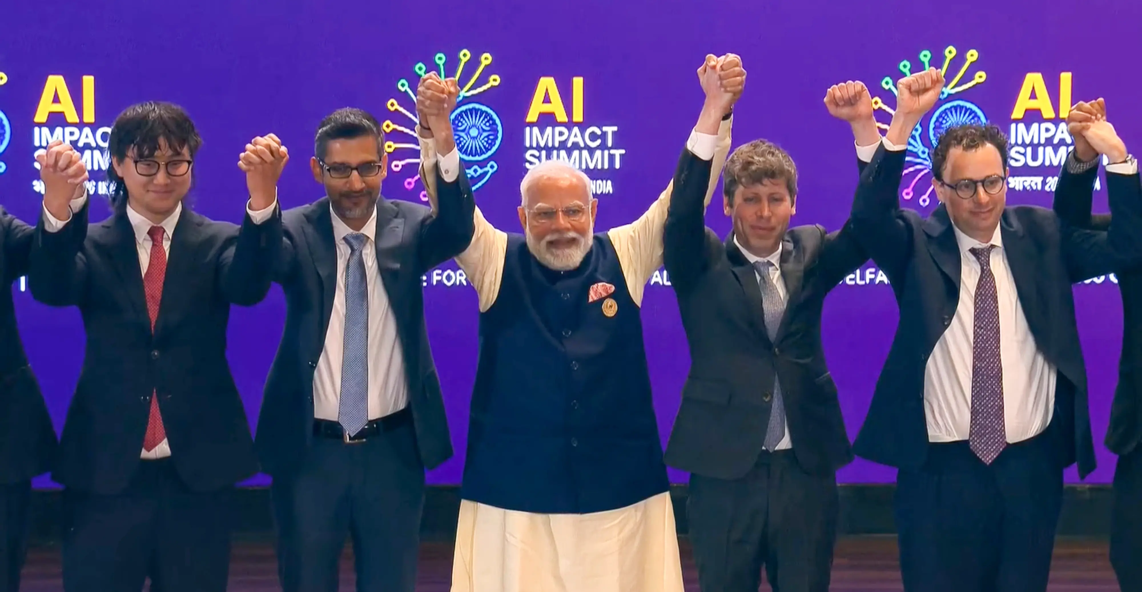 Prime Minister Narendra Modi, centre, joins hands with Google CEO Sundar Pichai, OpenAI CEO Sam Altman and others during the India AI Impact Summit 2026
