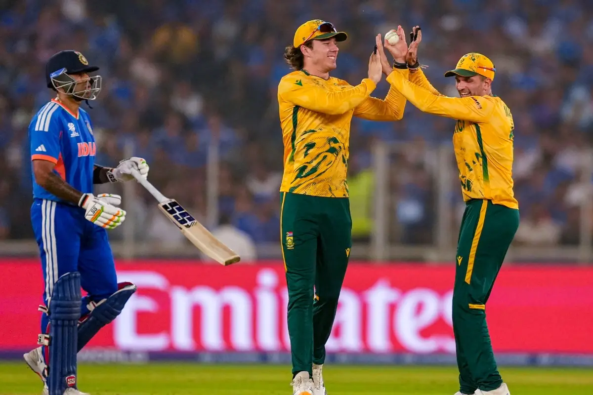 South Africa's Dewald Brevis, centre, celebrates with Keshav Maharaj, right, after taking the catch of India's captain Suryakumar Yadav | Photo: PTI