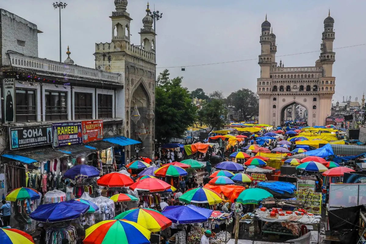 People seek shelter amid rainfall, at Charminar in Hyderabad, Monday, Feb. 23, 2026 (Photo: PTI)