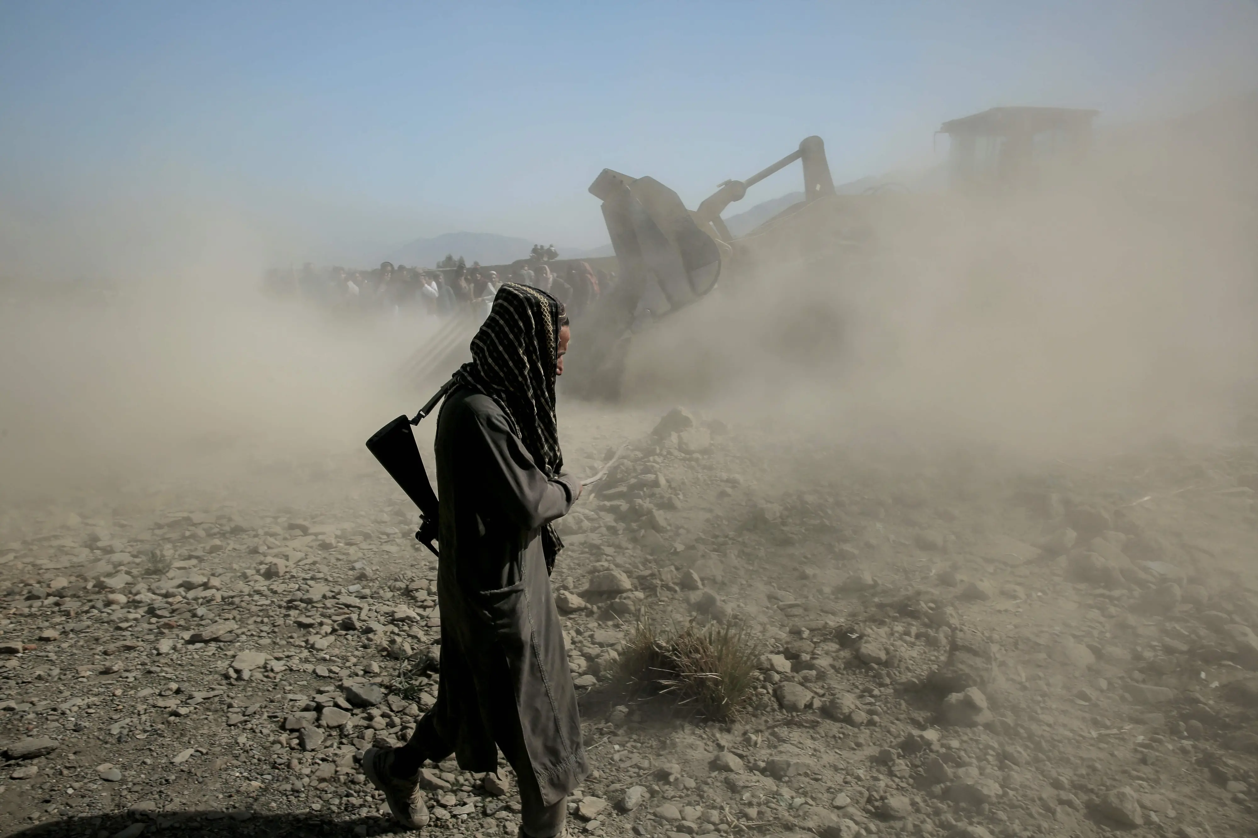 Taliban security personnel and residents search for victims after an overnight Pakistani air strike hit a residential area at the Girdi Kas village in Bihsud district | AFP