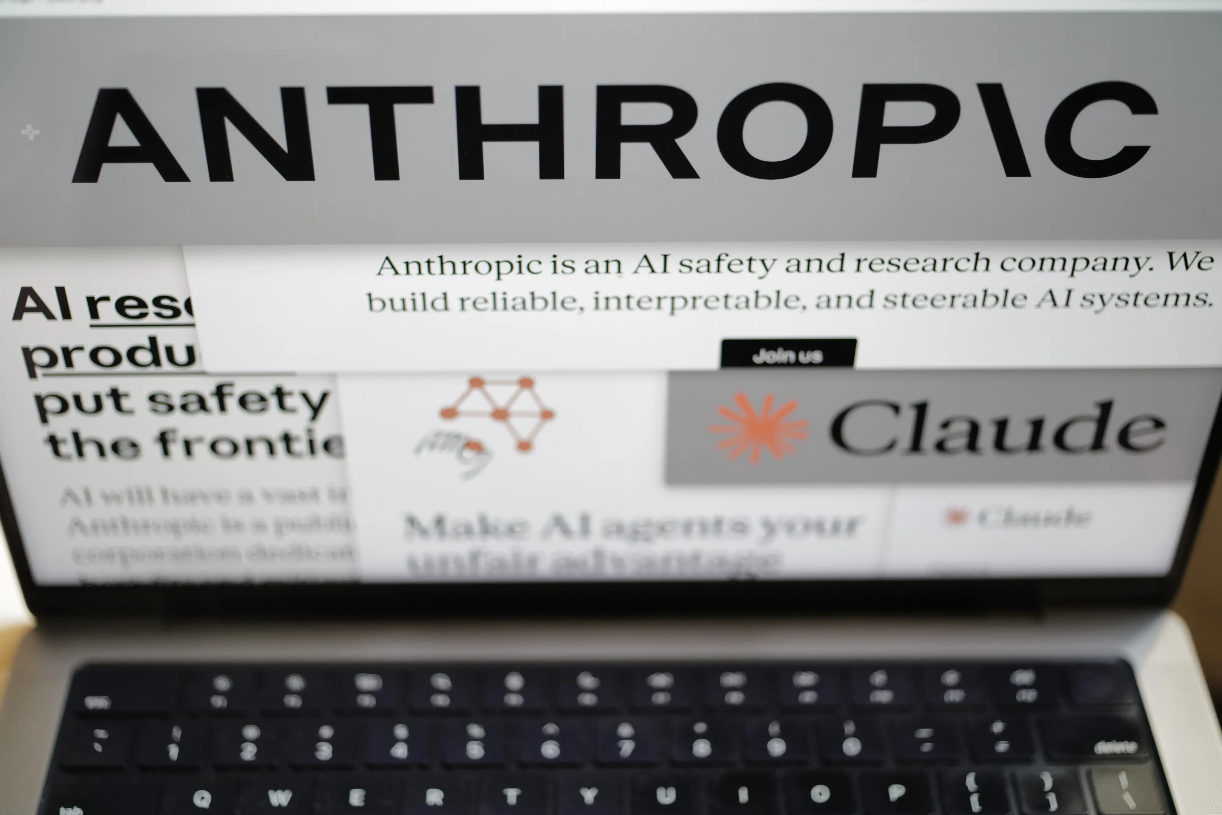 Pages from the Anthropic website and the company's logos are displayed on a computer screen in New York on Thursday, Feb. 26, 2026. (AP Photo/Patrick Sison)