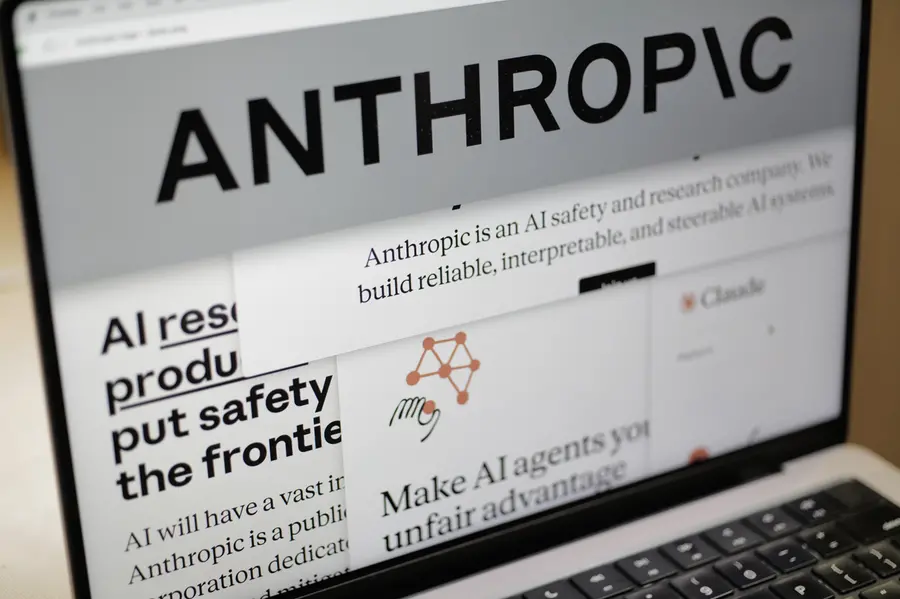 Pages from the Anthropic website and the company's logo are displayed on a computer screen