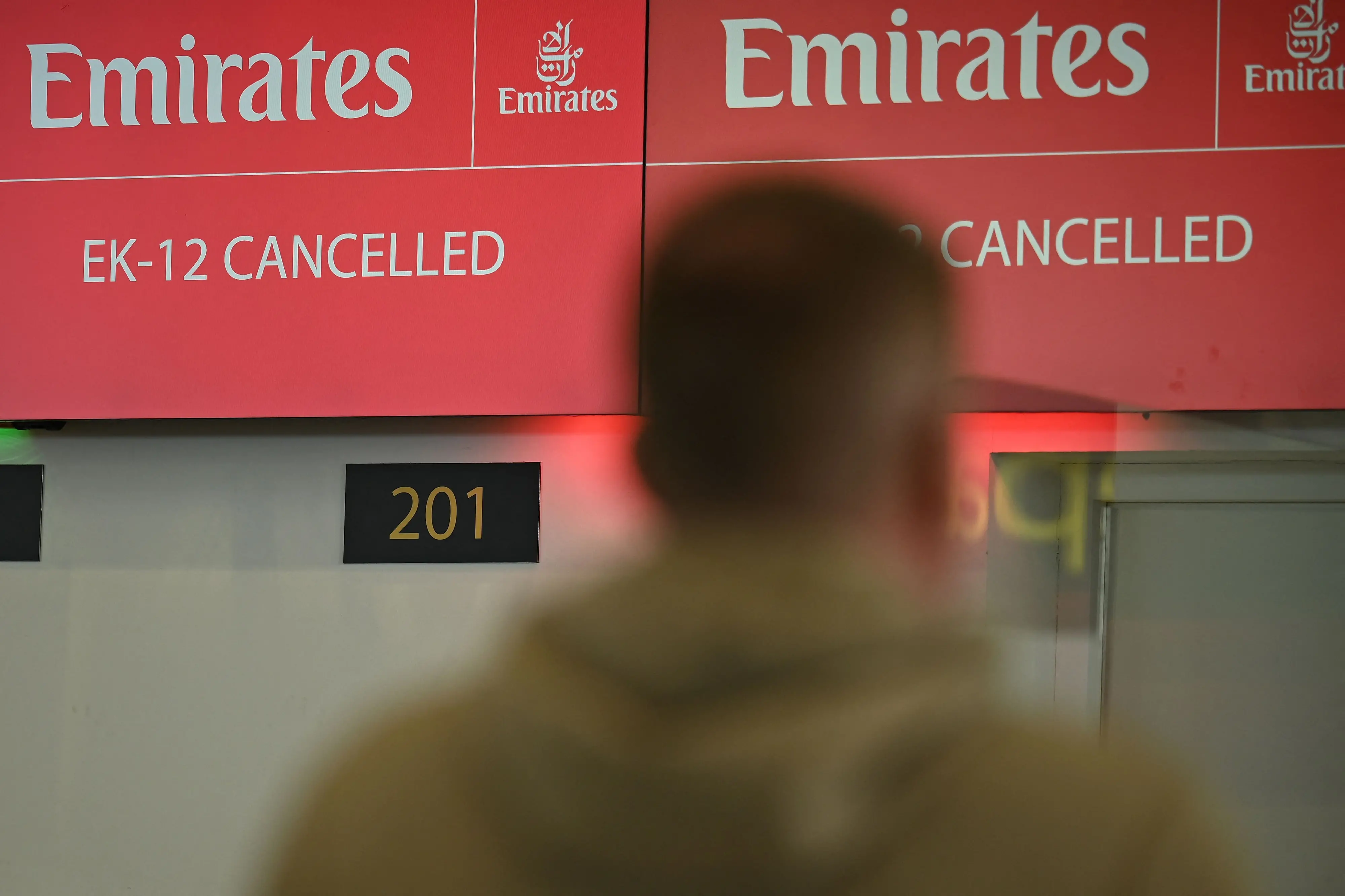 A check-in desk shows information on a cancelled flight in the north terminal at London Gatwick airport in Crawley | Photo: AFP