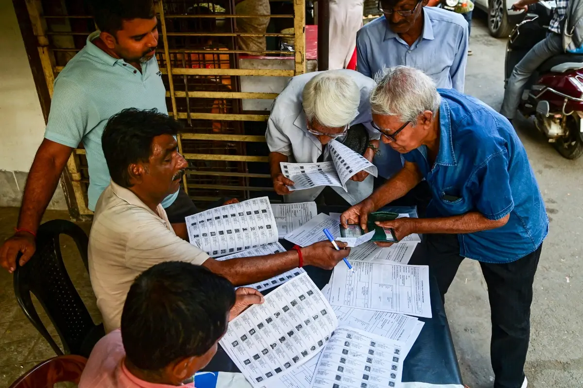 Voters check their names in the list after the Election Commission published West Bengal's post-SIR electoral rolls | Photo: PTI