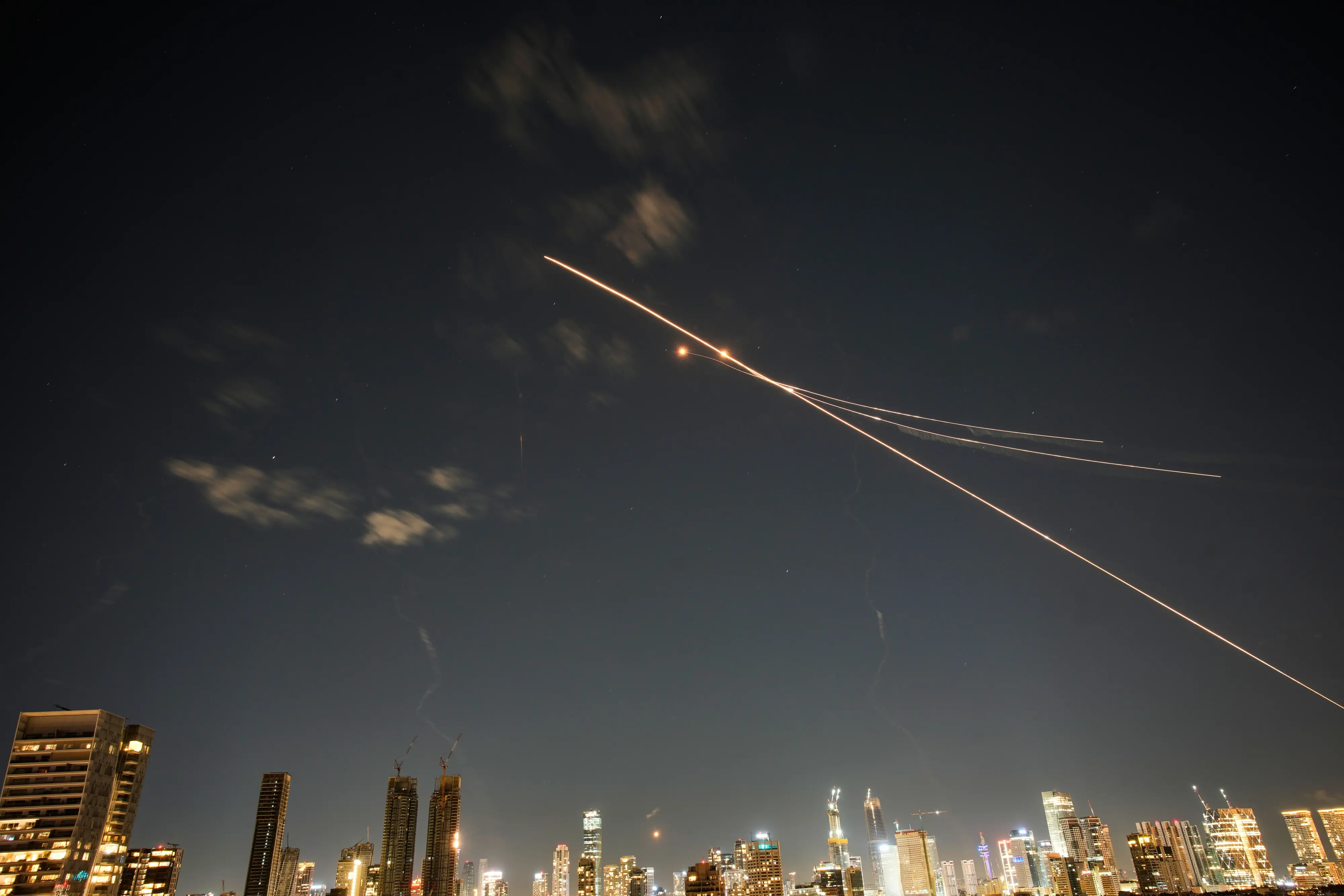 Traces of air defense missile interceptions are seen in Tel Aviv, Israel, Saturday, Feb. 28, 2026. (AP Photo/Ohad Zwigenberg)