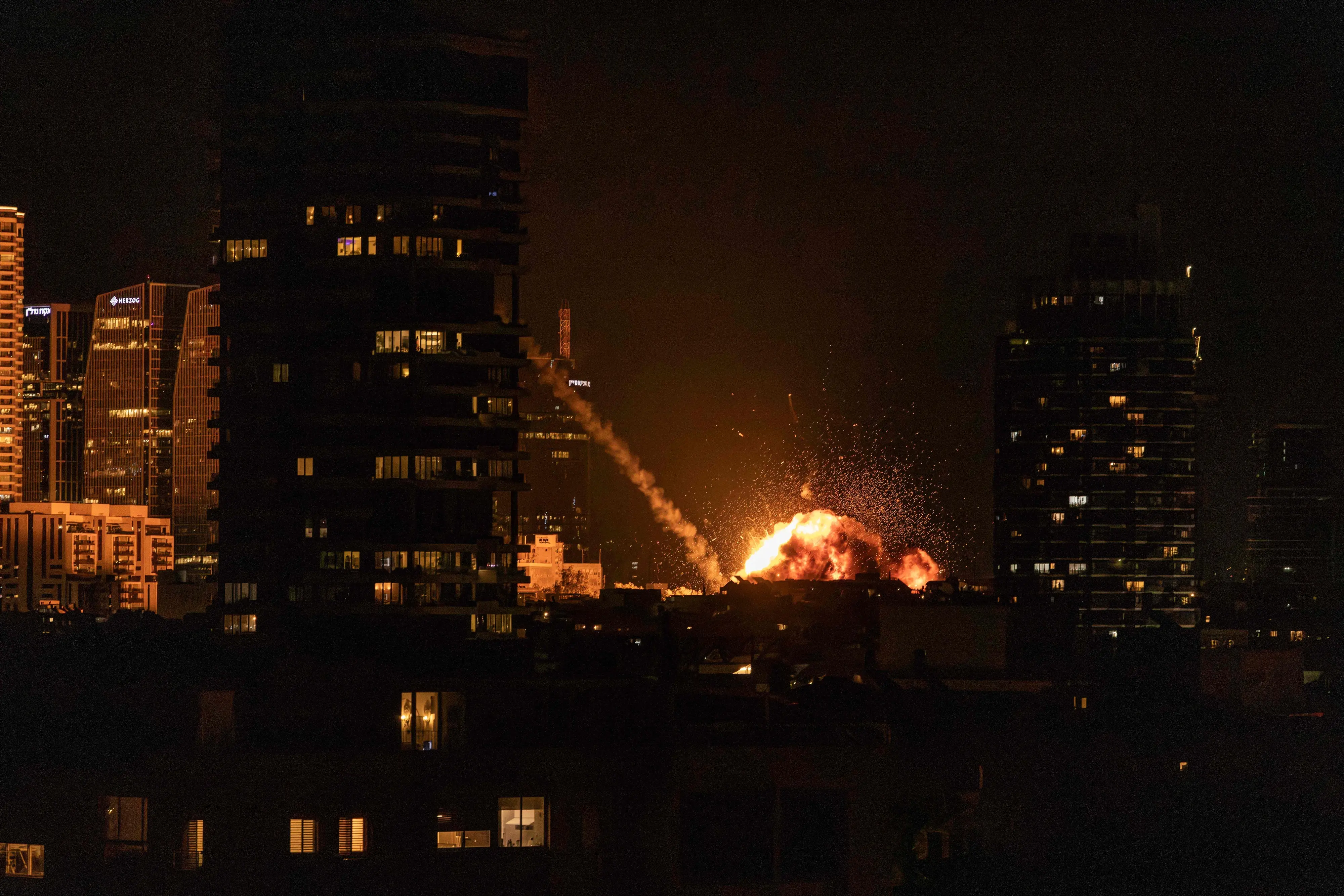 A fireball lights the sky following a missile strike on Tel Aviv | AFP