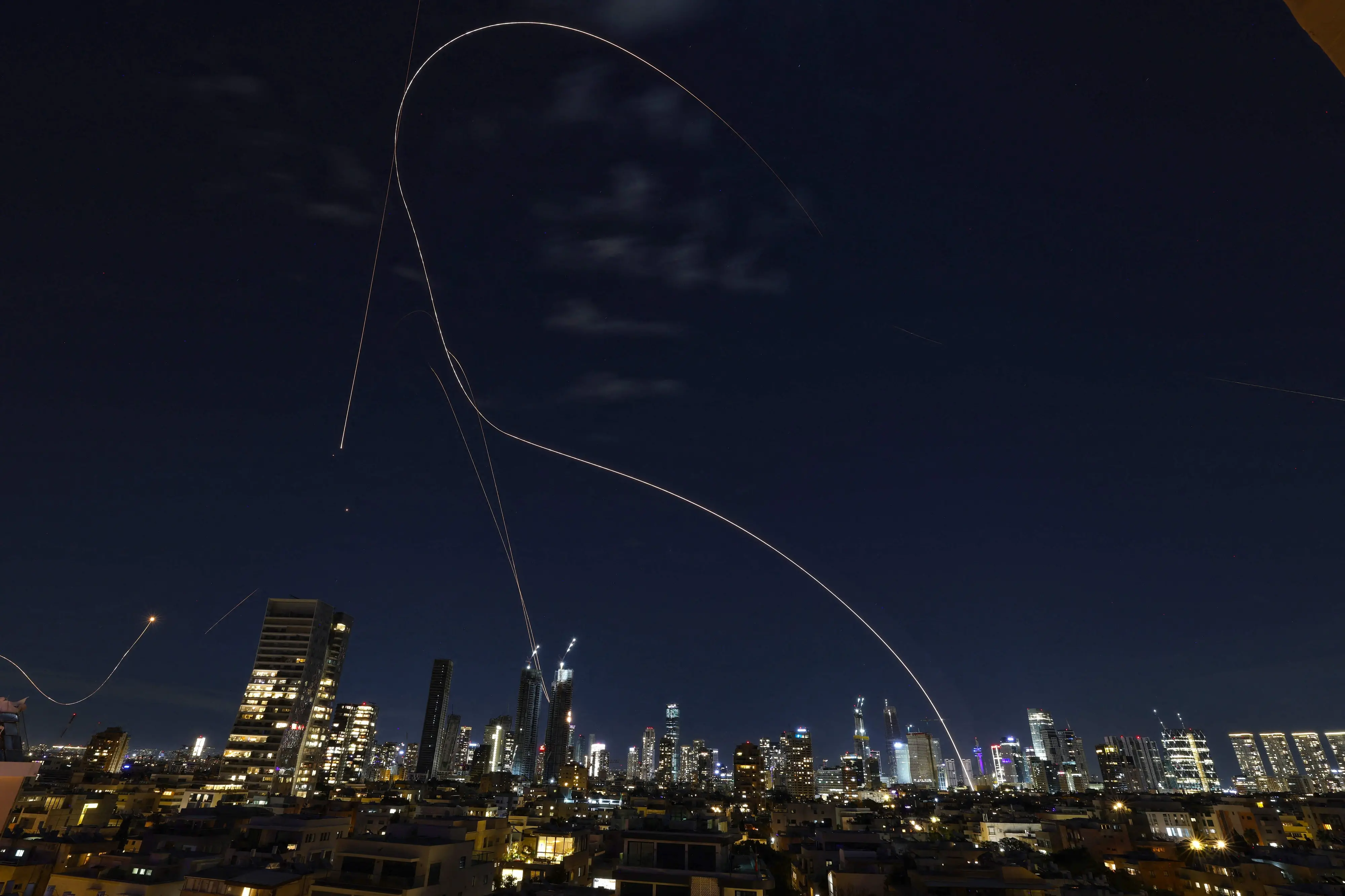 Rocket trails from an interception by Israel's Iron Dome missile defence system | AFP