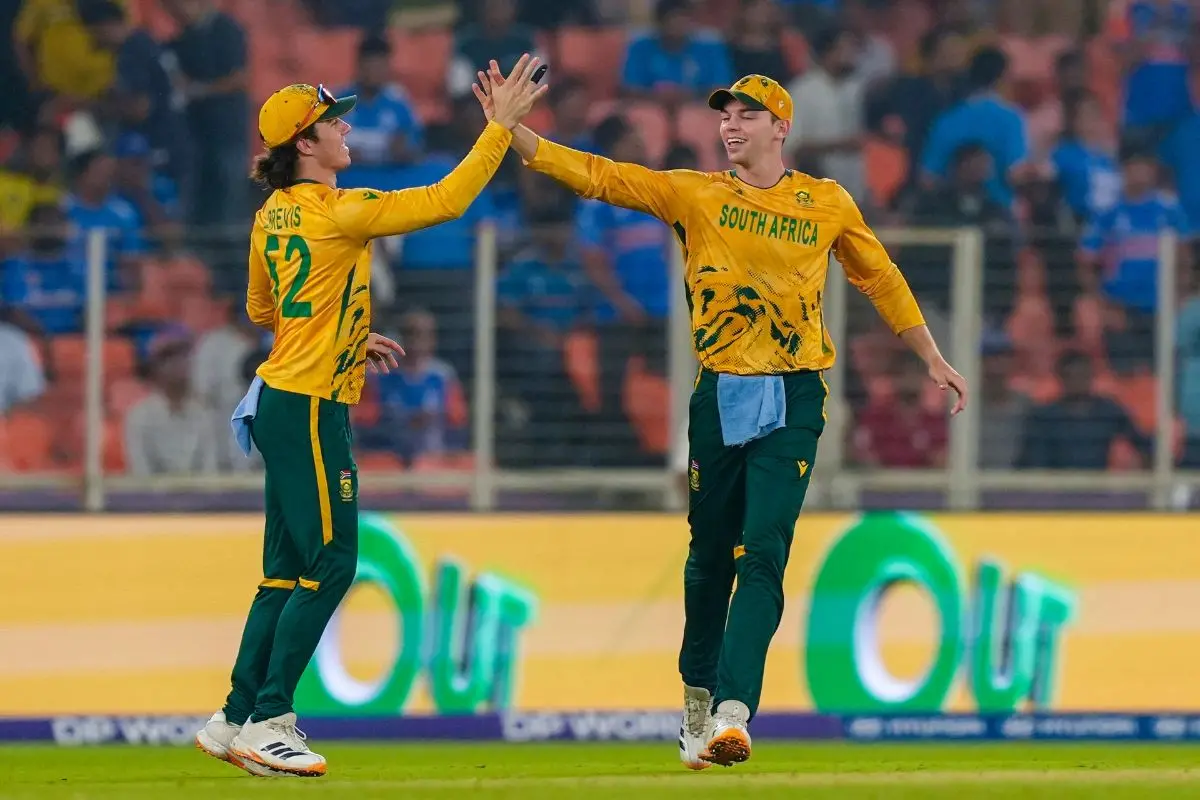 South Africa's Dewald Brevis, left, and Tristan Stubbs celebrate a wicket during an ICC Men's T20 World Cup 2026 cricket match between India and South Africa, at the Narendra Modi Stadium in Ahmedabad. | Photo: PTI