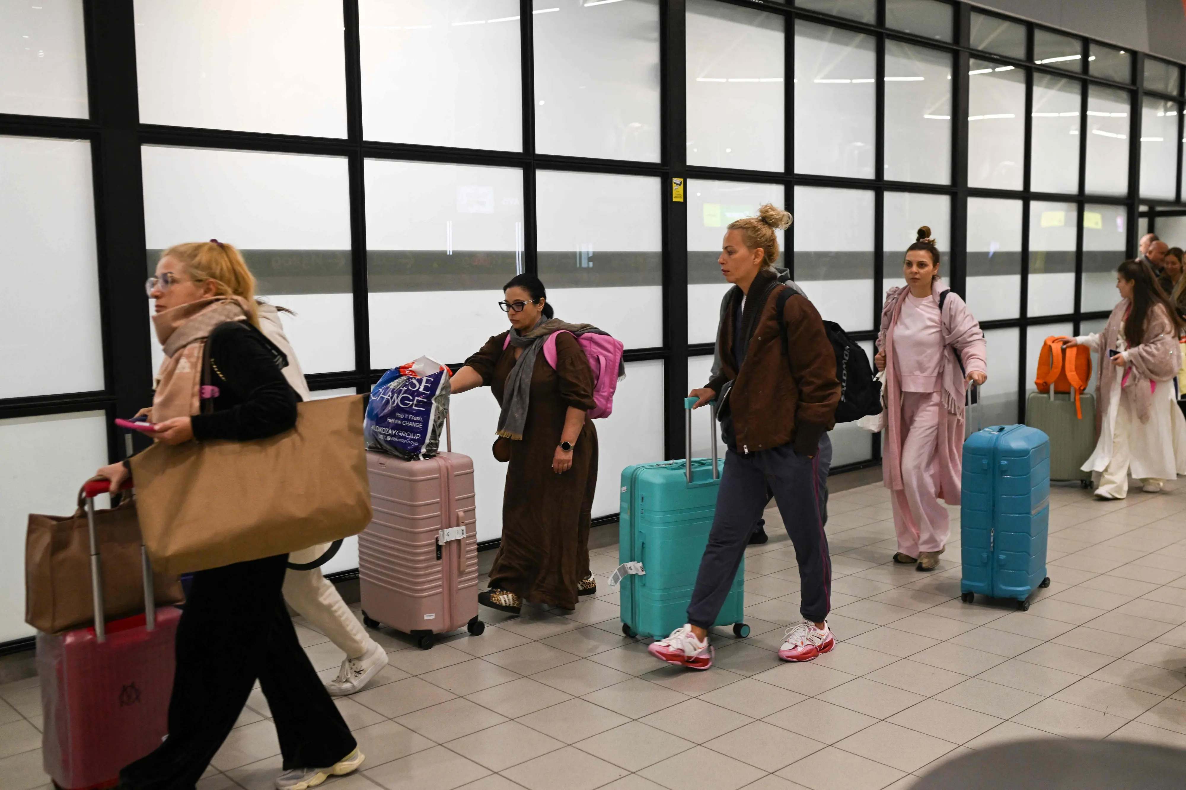 Air travelers, who were stranded in Dubai, arrive at Vassil Levski Internationl Airport in Sofia, Bulgaria | AFP