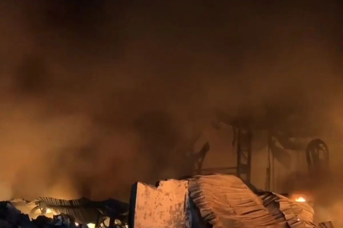 Thick plumes of black smoke rise as firefighters deploy multiple tenders to douse a massive blaze at a paint factory in Ghaziabad's Mainapur Industrial Area on Meerut Road. ANI Screengrab