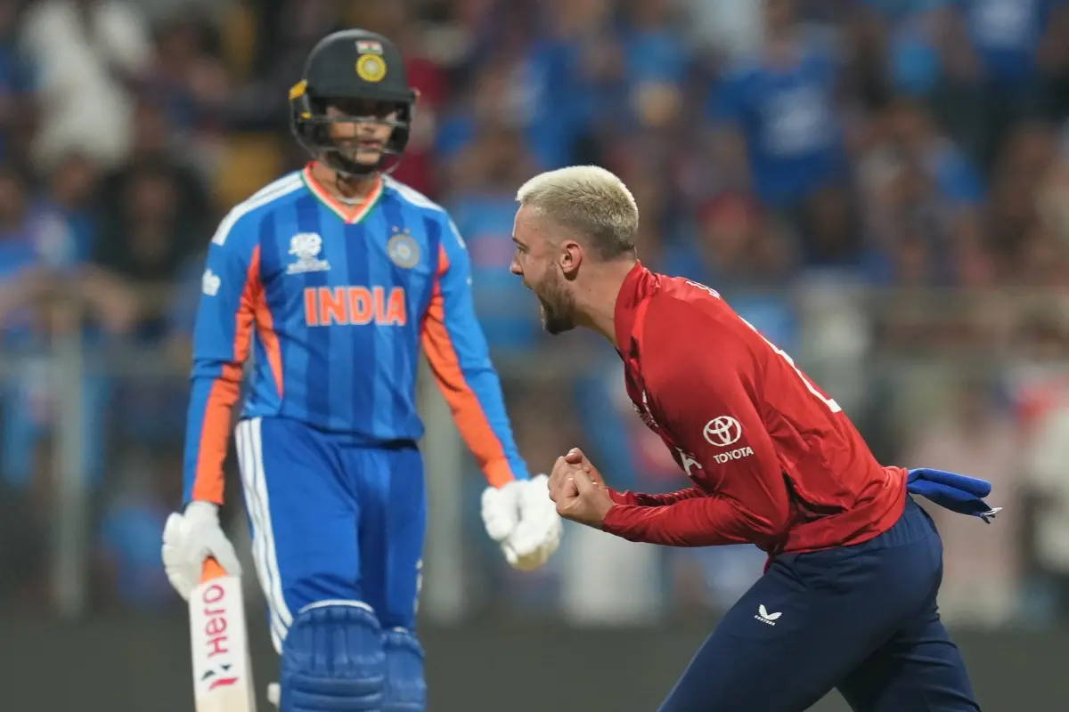 England's Will Jacks, right, celebrates the dismissal of India's Abhishek Sharma, left, during the T20 World Cup cricket semi-final match between India and England in Mumbai. | Photo: AP