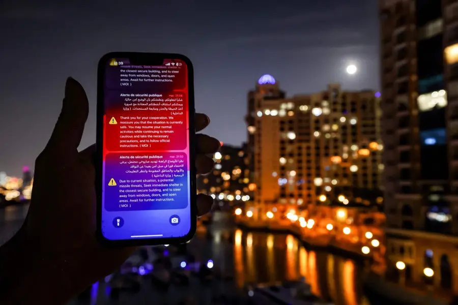 An alert issued by the UAE Ministry of Interior warning residents of Dubai and Abu Dhabi of a potential Iranian missile strike is displayed on a mobile phone shortly before a missile was intercepted in Dubai