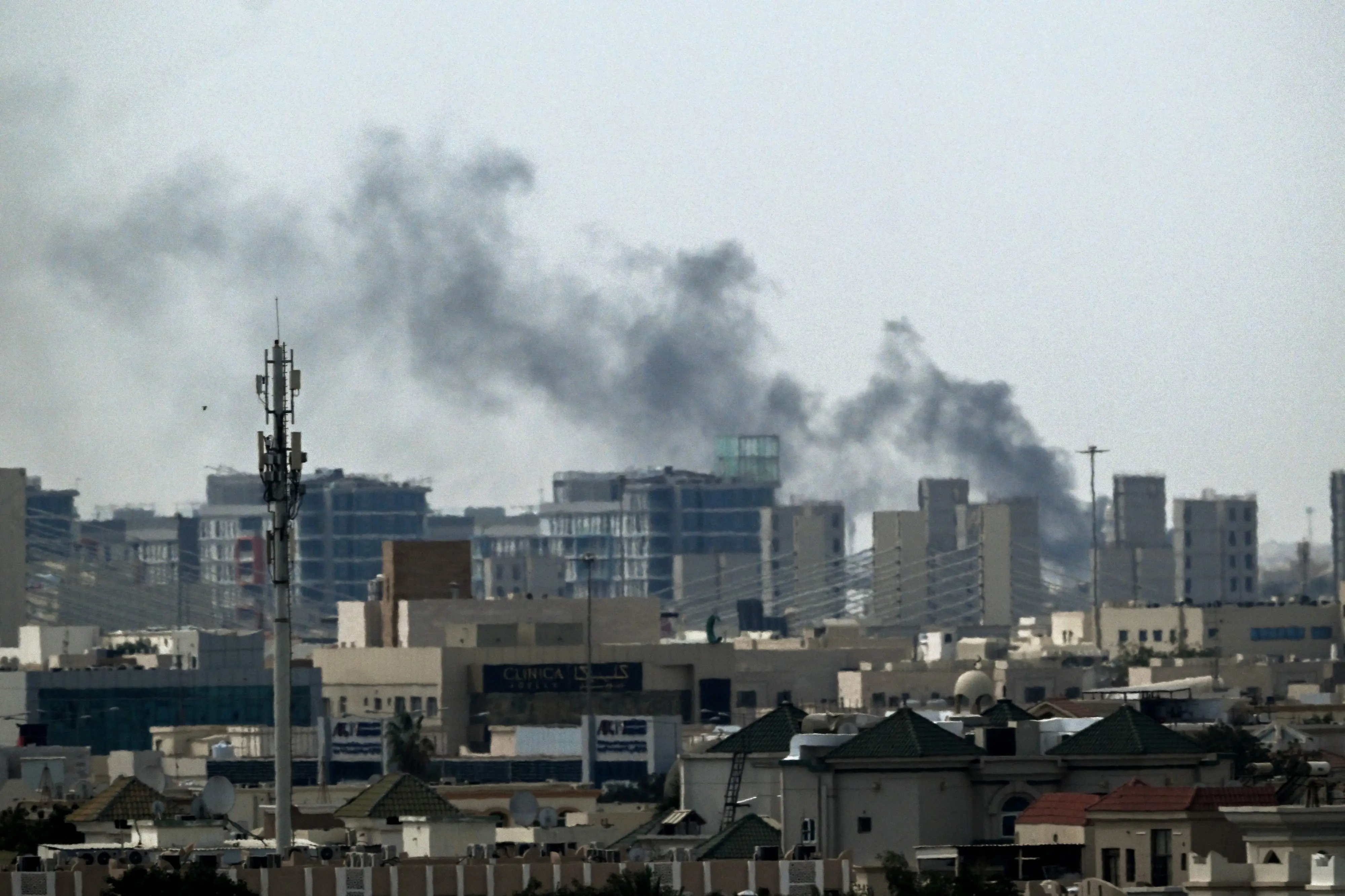 A plume of smoke rises over buildings in Doha on March 5, 2026 | Photo: AFP