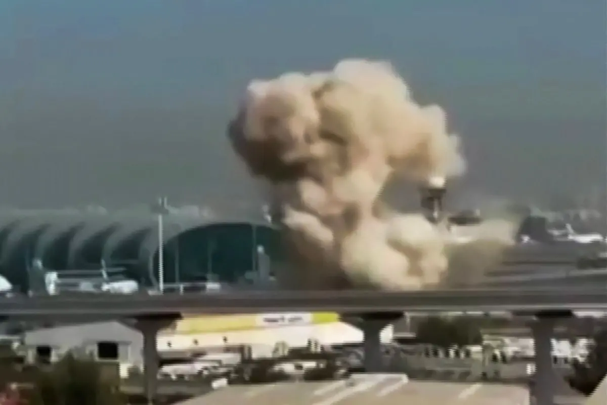 This video grab taken from UGC images shows smoke rising from the Dubai International Airport. Dubai airport, the world's busiest for international traffic, suspended operations on March 7 before partially resuming services, after an air defence interception in the area during attacks from Iran. (Photo by various sources / AFP)