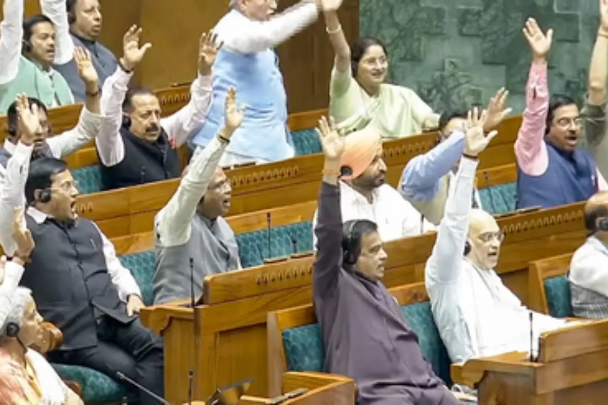 Members of Parliament raise their hands during a voice vote in the Lok Sabha as the House defeats the no-confidence motion against the Speaker after a marathon debate during the Budget Session in New Delhi. (Photo: IANS)