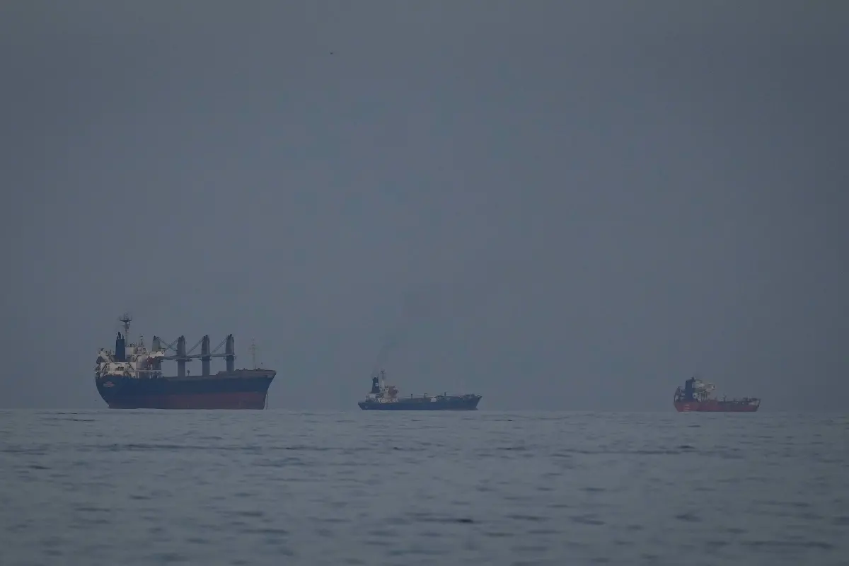Oil tankers and ships line up in the Strait of Hormuz as seen from Khor Fakkan, United Arab Emirates, Wednesday
